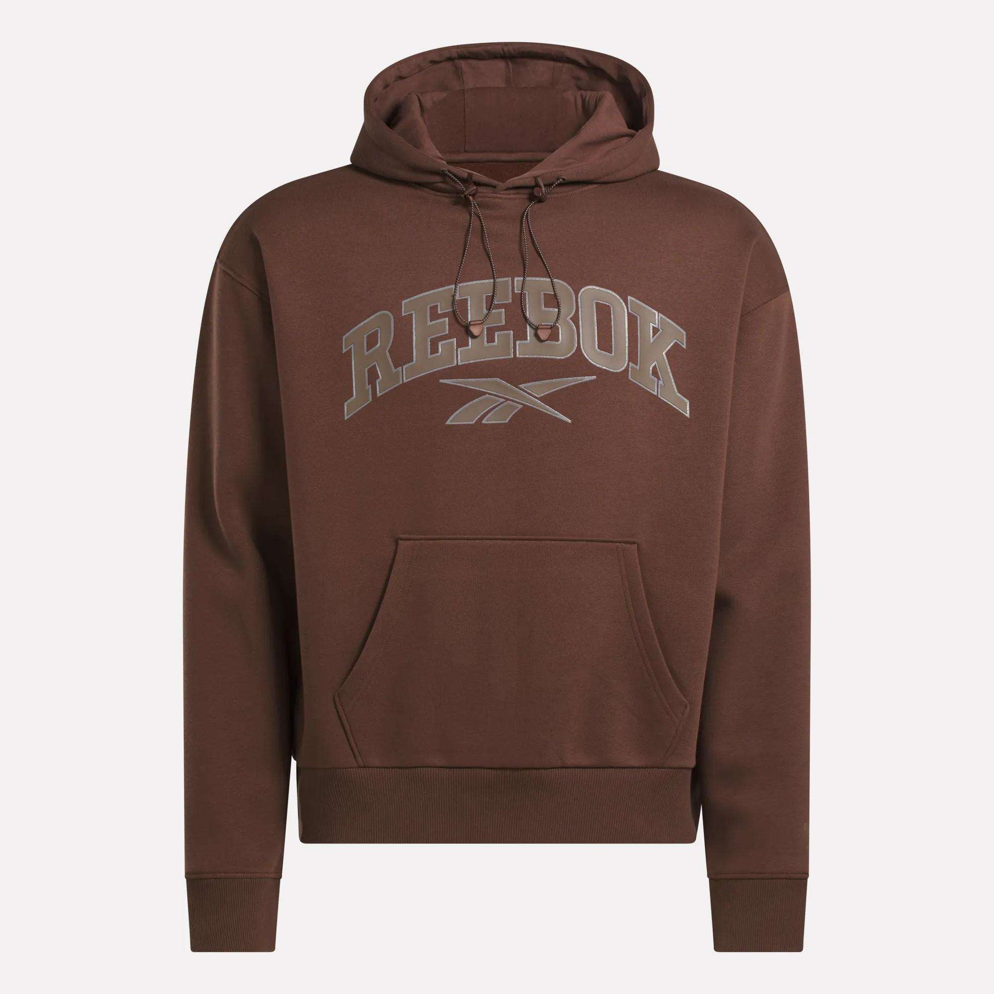 The Reebok Men's Varsity Hoodie features a brown collegiate style, front pocket, drawstring hood, and bold gray Reebok logo text across the chest—ideal for a casual men's jacket look.