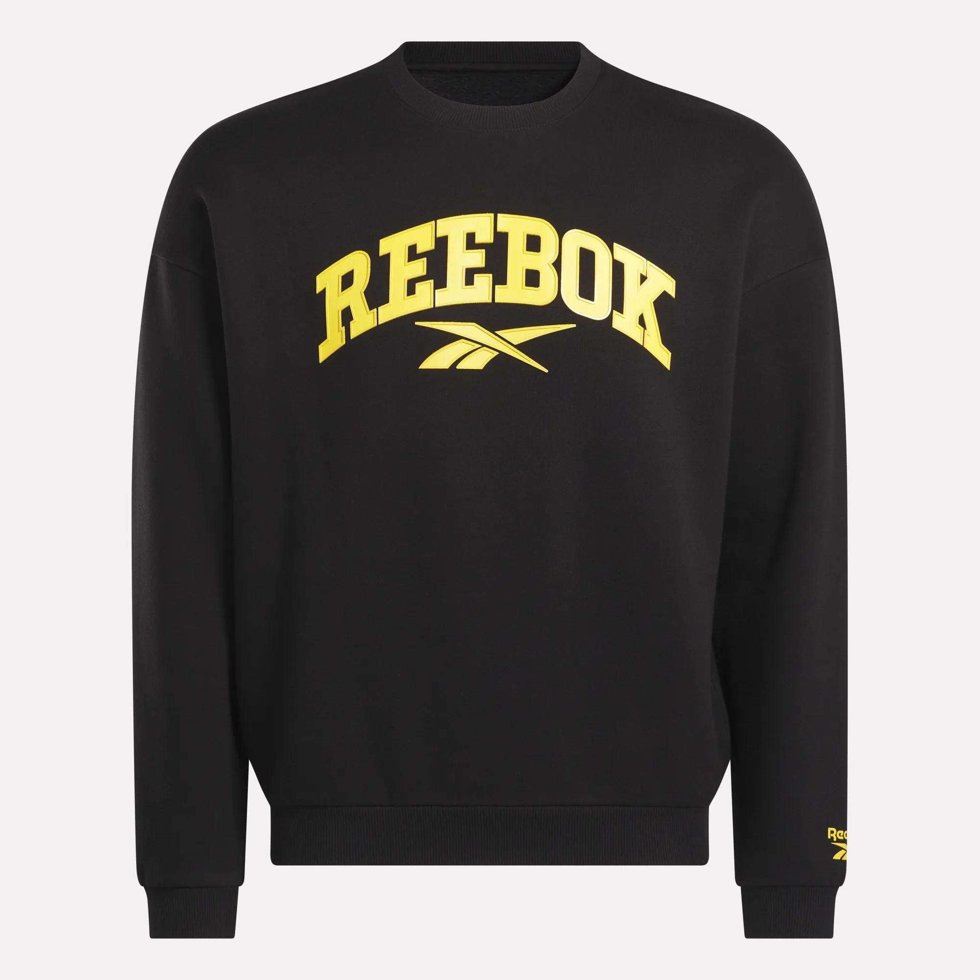 The Reebok Men's Cottle Sweatshirt is black with bold yellow "REEBOK" lettering and logo on the front, plus a small yellow Reebok logo on the lower left sleeve.