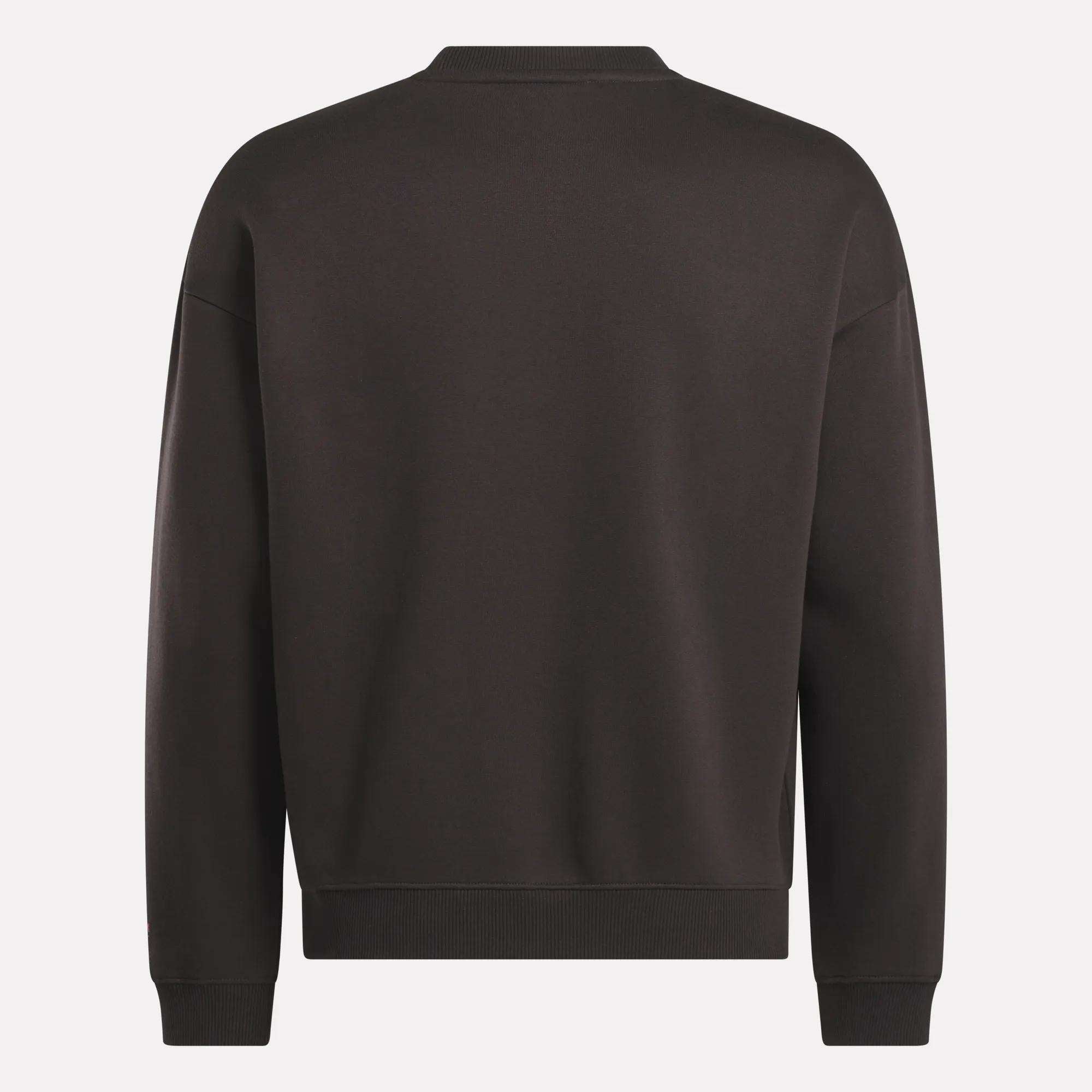 The image shows the back of Reebok's Men's Varsity Sweatshirt, a plain black design with long sleeves, crew neckline, and ribbed cuffs and hem.