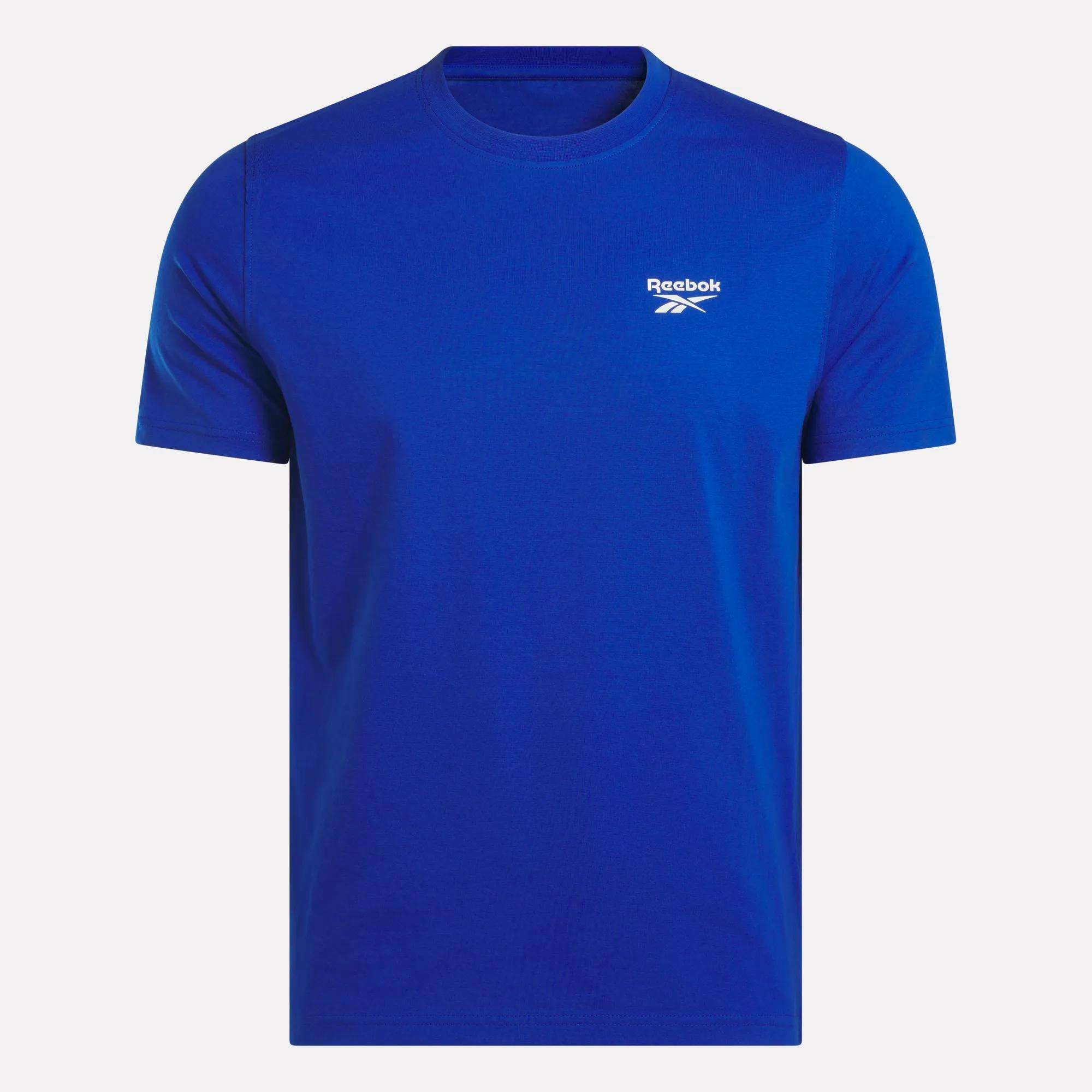 The Reebok Men's Small Logo Crewneck Short Sleeve T-Shirt, shown on a white background, features soft cotton jersey fabric and a small white Reebok logo with text on the left chest.