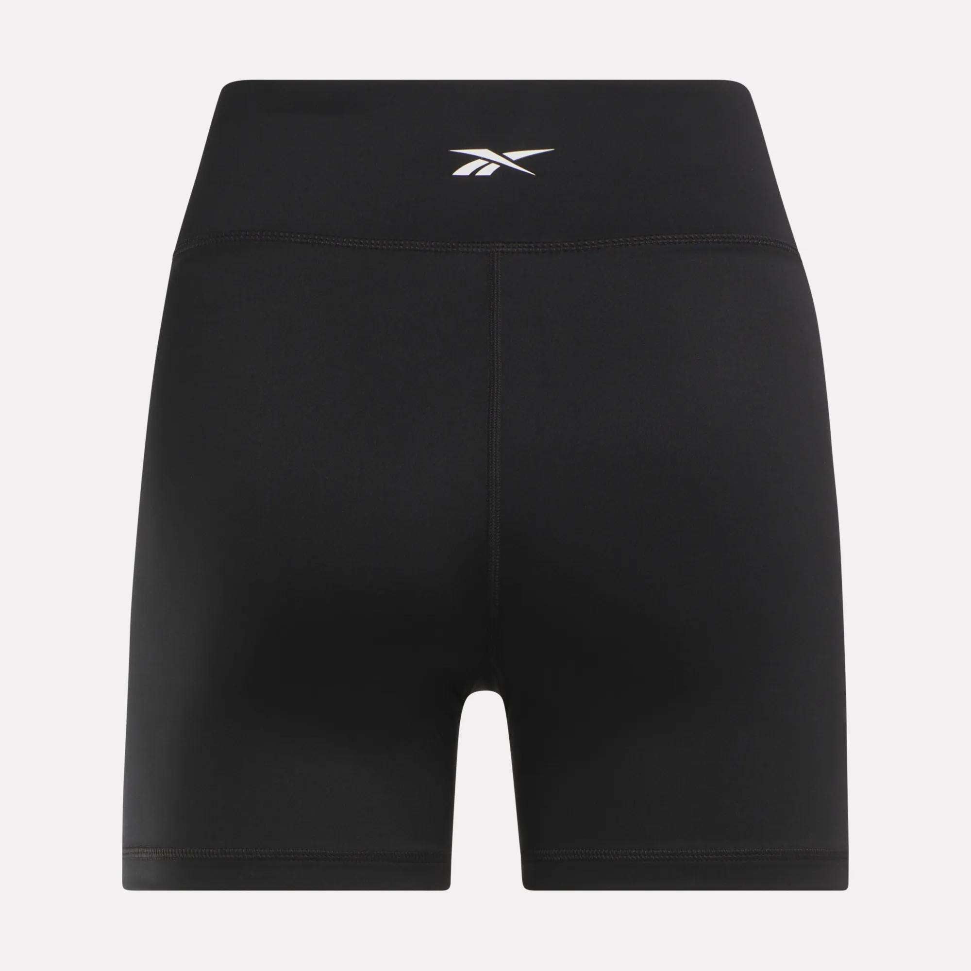 Women's Core High-Rise Shorts by Reebok are black, sweat-wicking shorts featuring a small white logo centered on the waistband, shown against a plain light background.