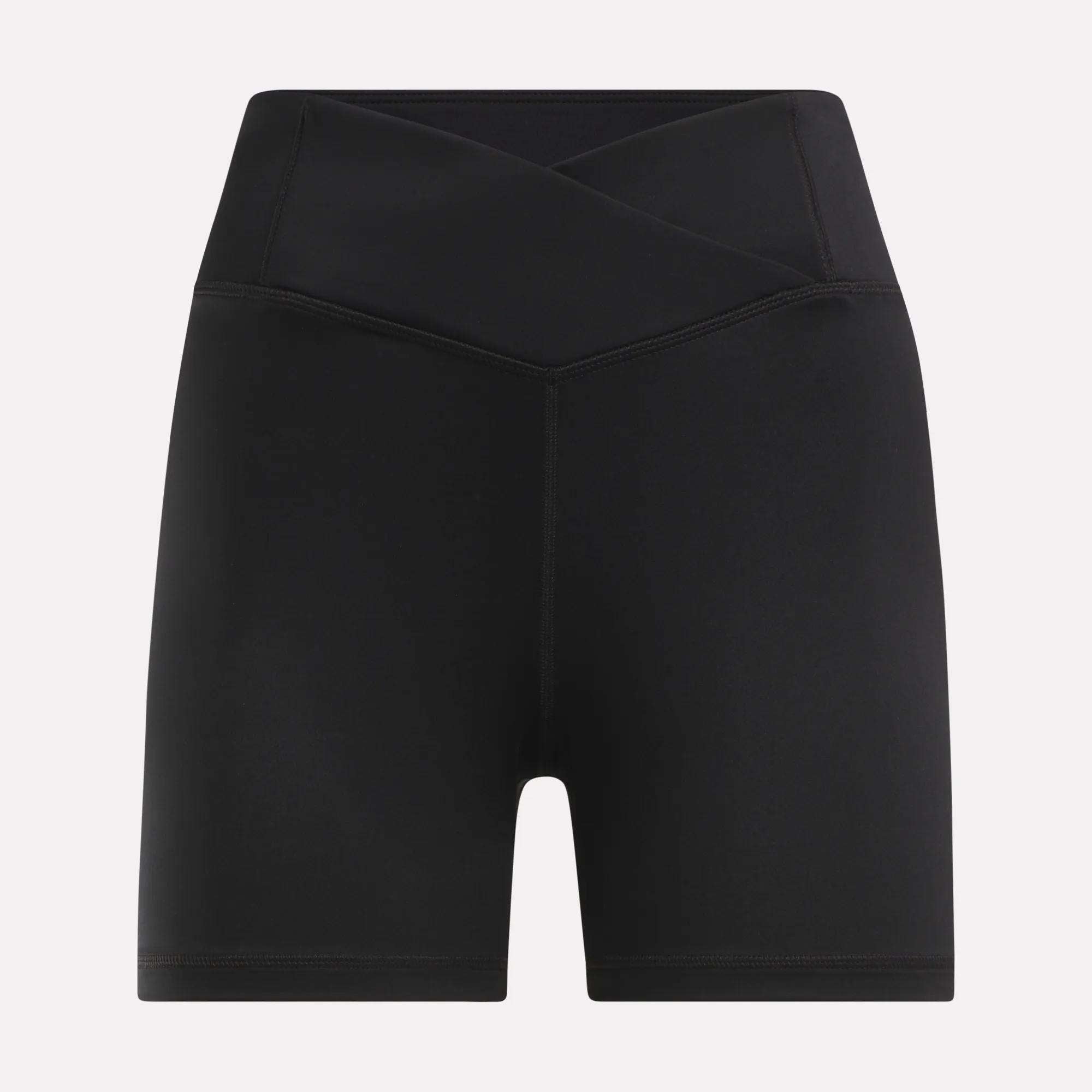 The Reebok Women's Core High-Rise Shorts feature a crisscross waistband and sweat-wicking fabric, shown in black against a plain white background.
