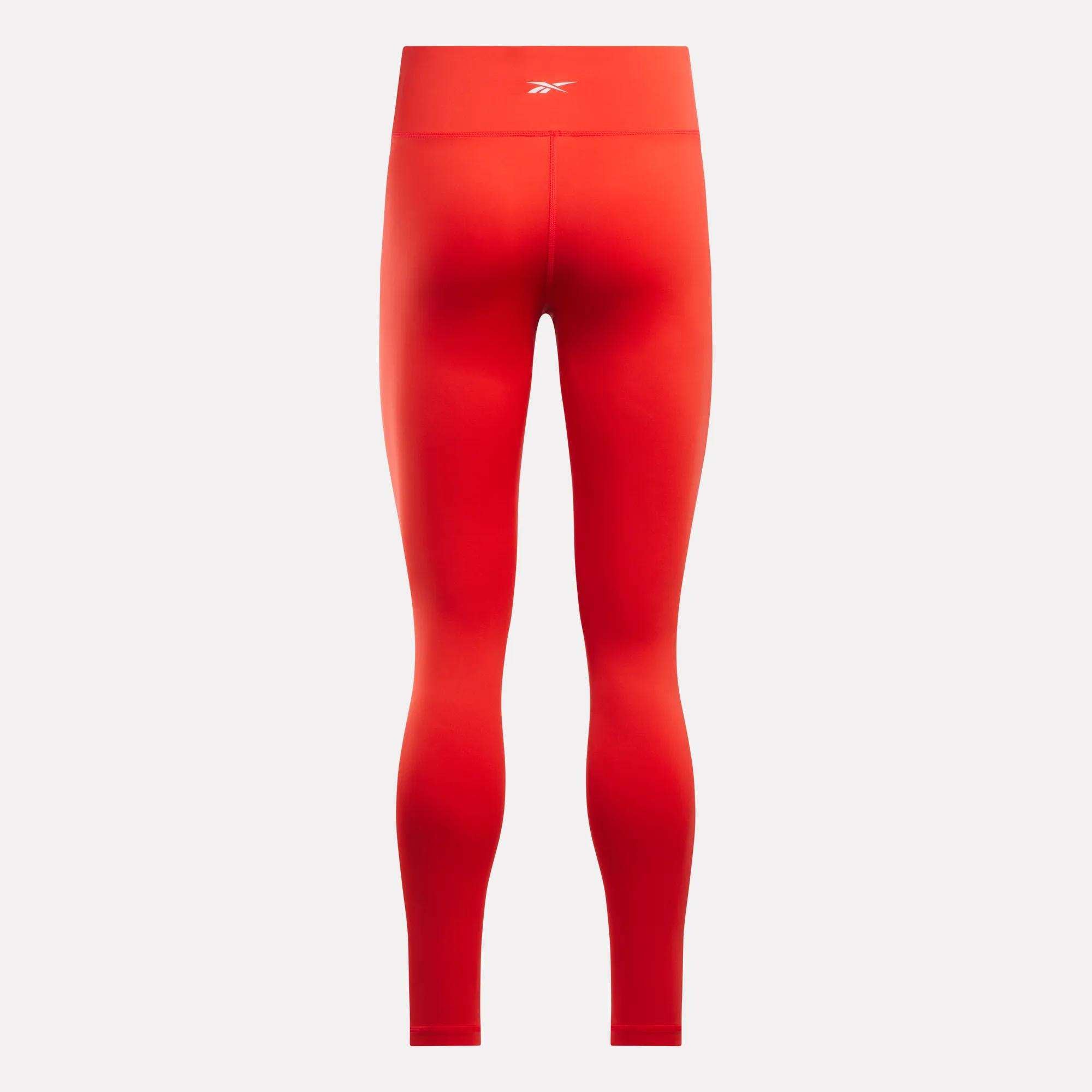 Women's Core High-Rise Leggings by Reebok in bright red, shown from the back with a small white logo at the waistband; seamless, fitted design and moisture-wicking RBK-DRY fabric ensure comfort during workouts.