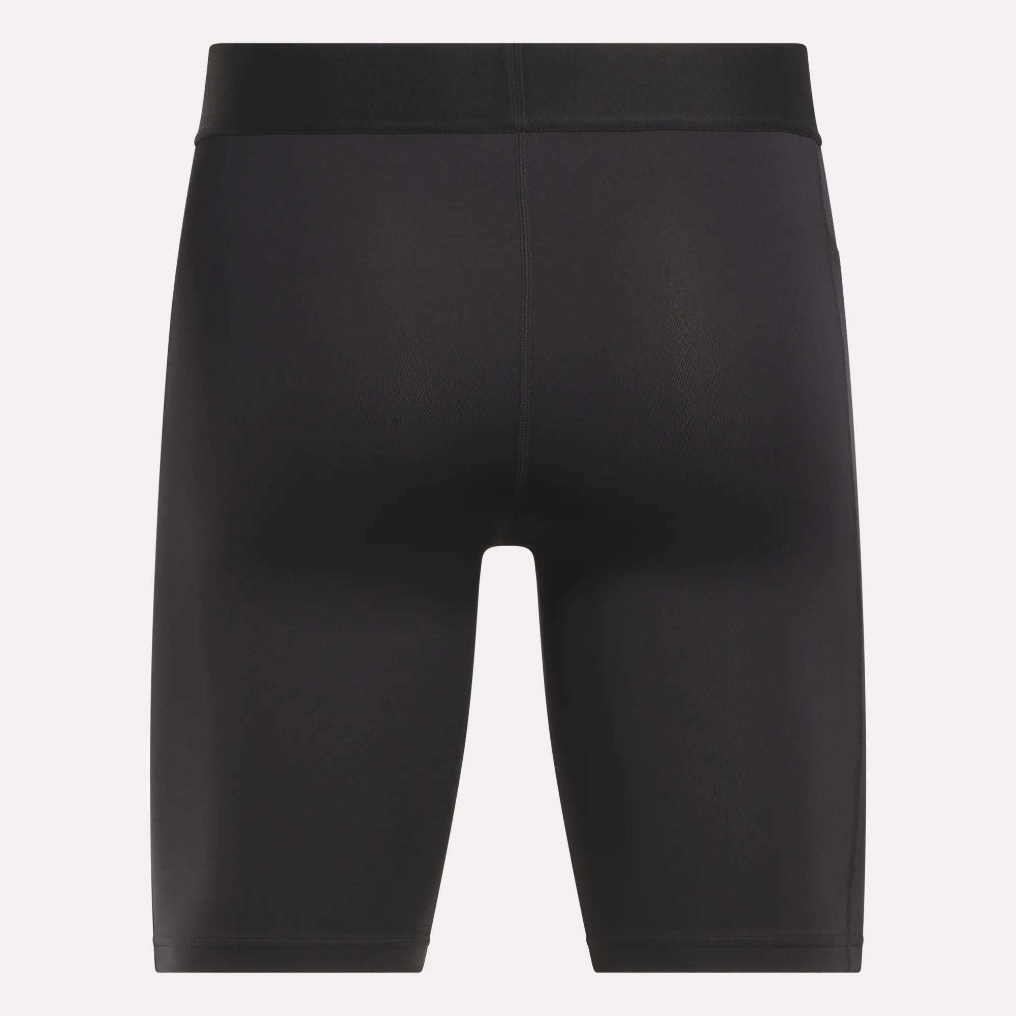 Reebok Men's Training Short Tights: plain black, knee-length, fitted design with no visible logos or patterns. Made from sweat-wicking recycled polyester; shown from the back against a white background.