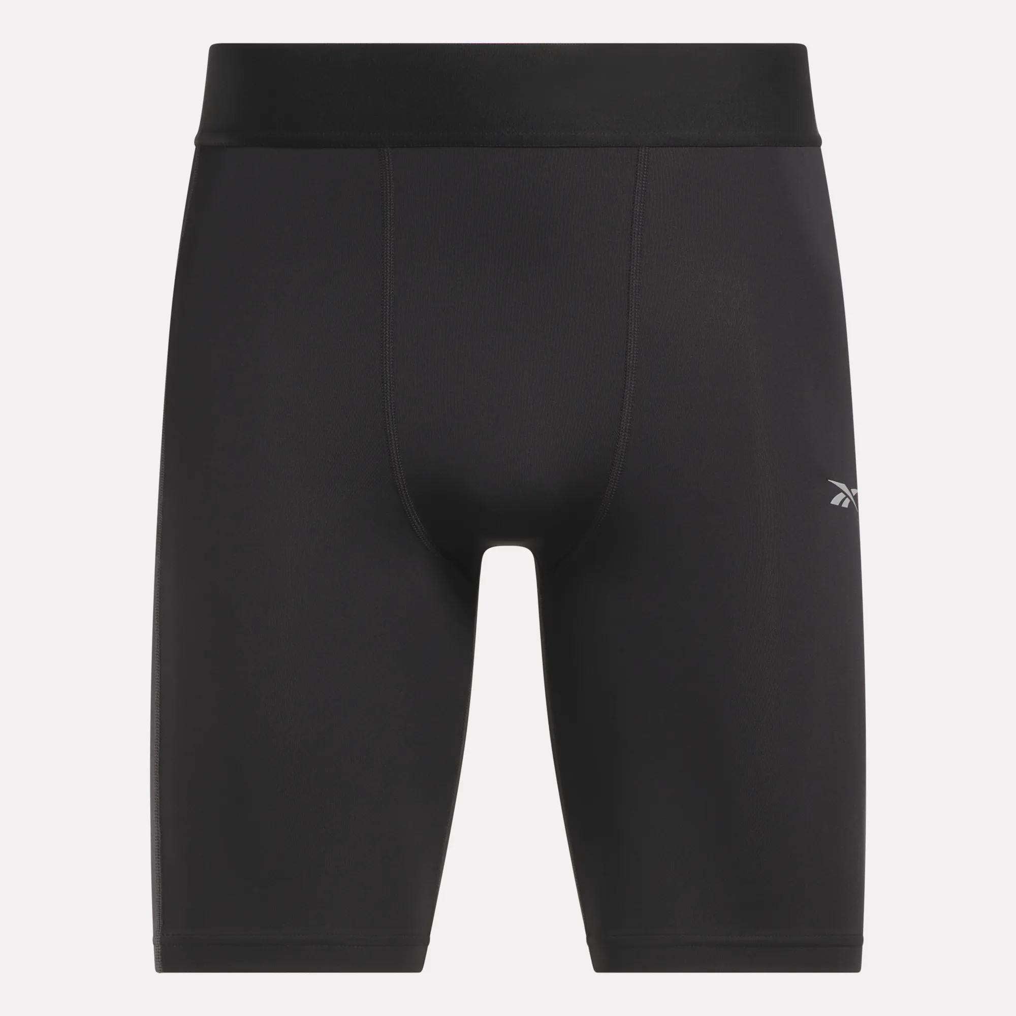 Reebok Men's Training Short Tights in black, made from recycled polyester with a wide waistband, sweat-wicking fabric, and a small white logo on the left thigh, shown against a plain white background.