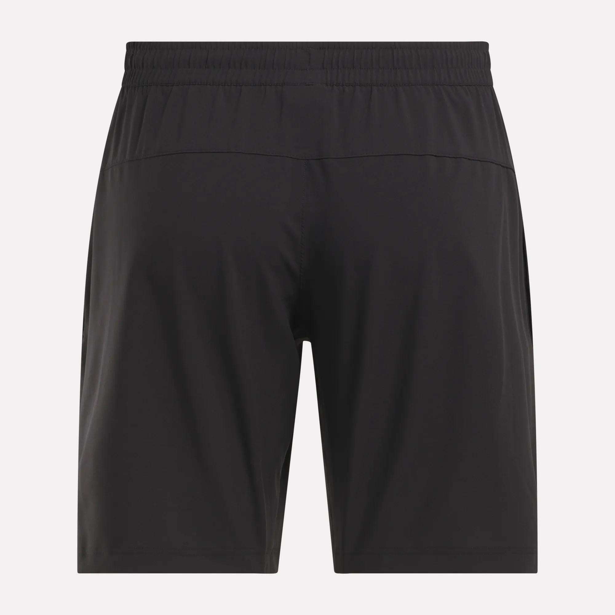 Back view of Reebok Men's Workout Ready Woven Shorts in plain black with elastic waistband, shown against a light background—men's sweat-wicking workout shorts designed for lasting comfort.