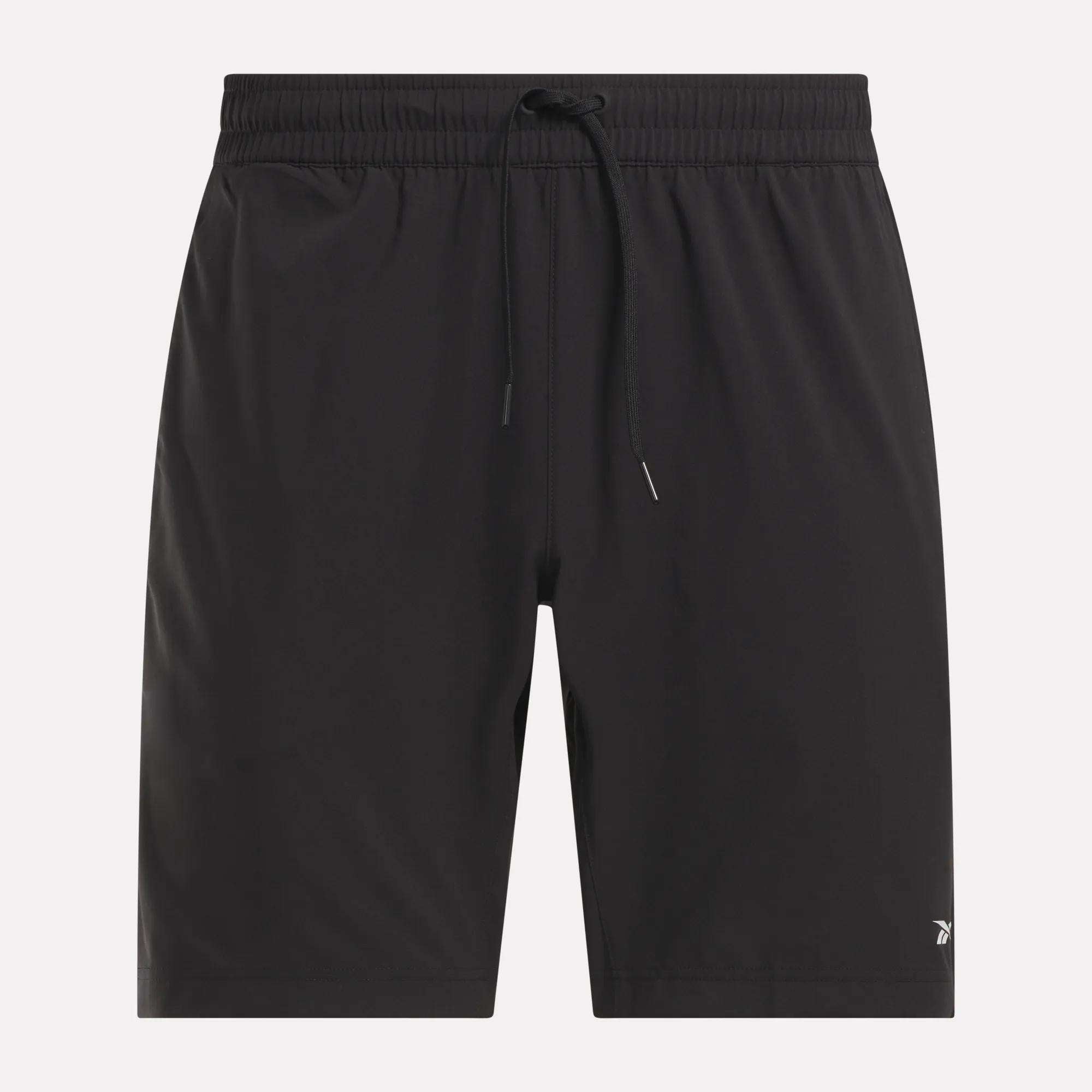 The Reebok Men's Workout Ready Woven Shorts feature a black, sweat-wicking fabric, elastic waistband with adjustable drawstring, and a small white logo on the lower left leg. Perfect for any workout. Displayed against a light background.