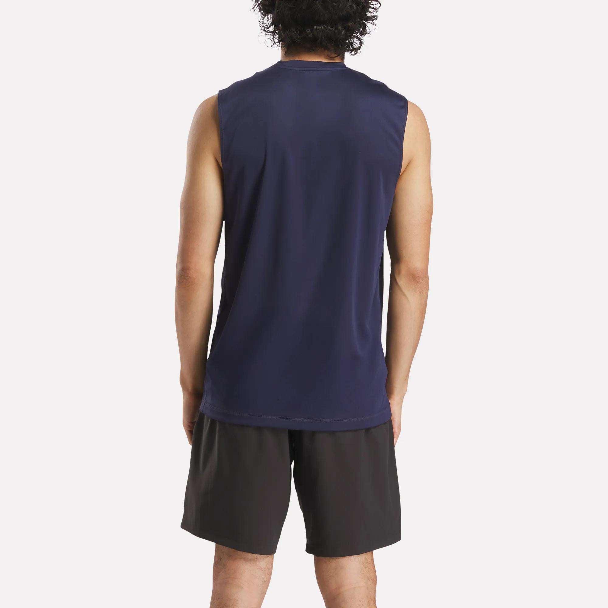 A person with curly hair stands with their back to the camera, wearing the Reebok Men's Train Sleeveless Tech Tee and black athletic shorts against a plain white background.