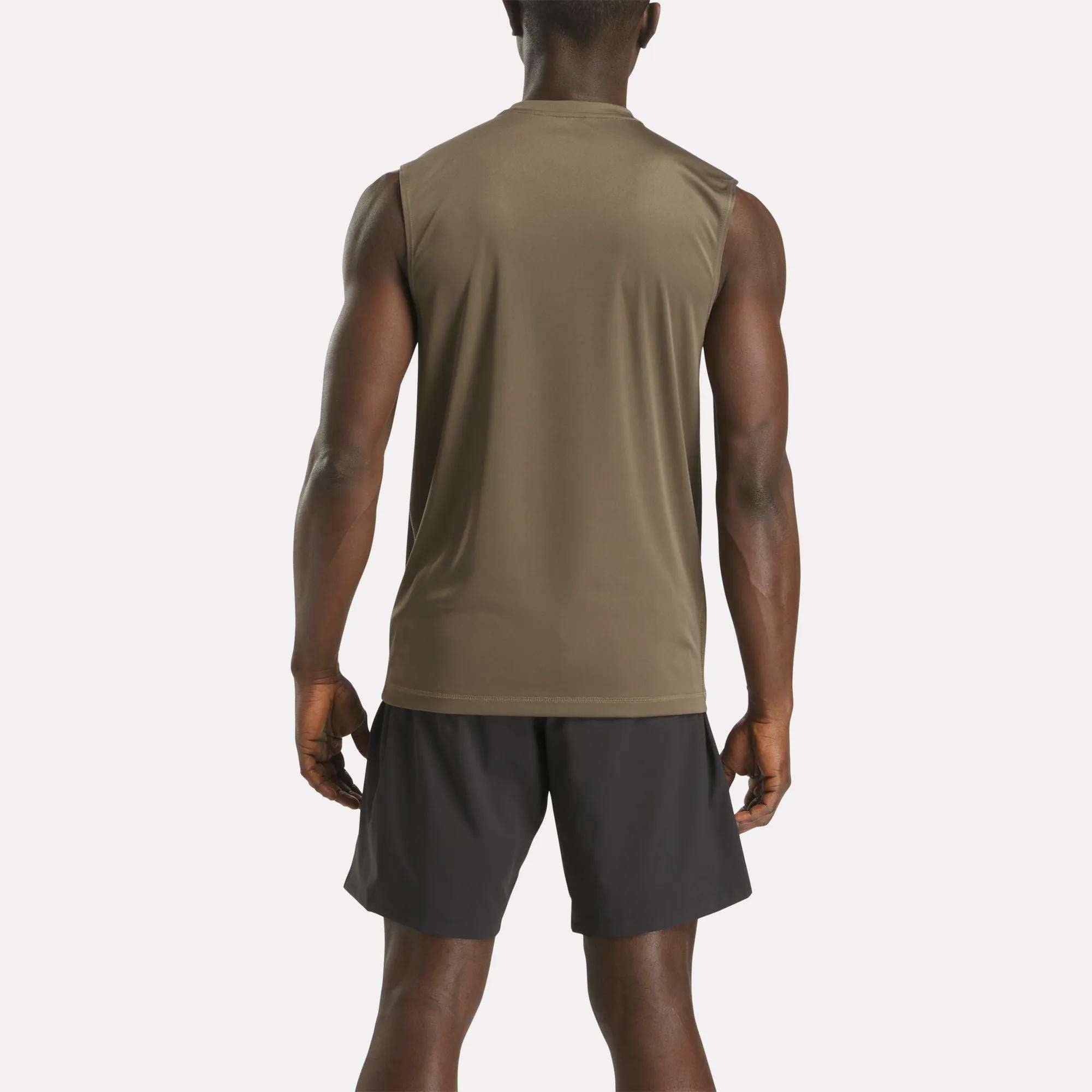 A man stands with his back to the camera, wearing a Reebok Men's Train Sleeveless Tech Tee in olive green and black athletic shorts, set against a plain light background.