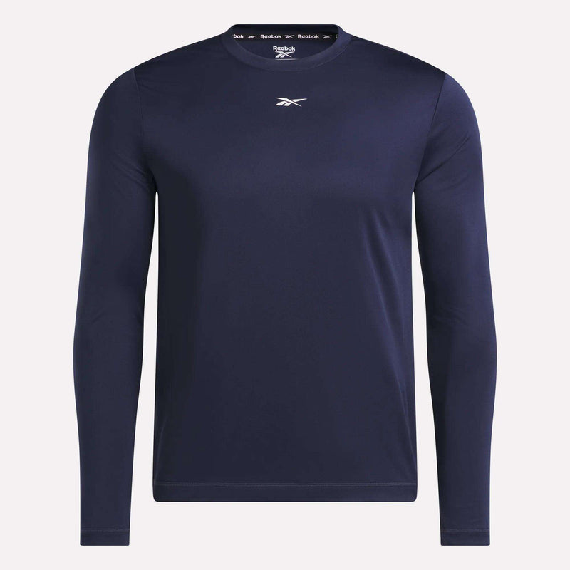 The Men’s Long Sleeve Tech T-Shirt from Reebok features a navy blue color, crew neck, and long sleeves, with a small white Reebok logo on the chest—ideal for cold weather workouts and shown against a plain background.
