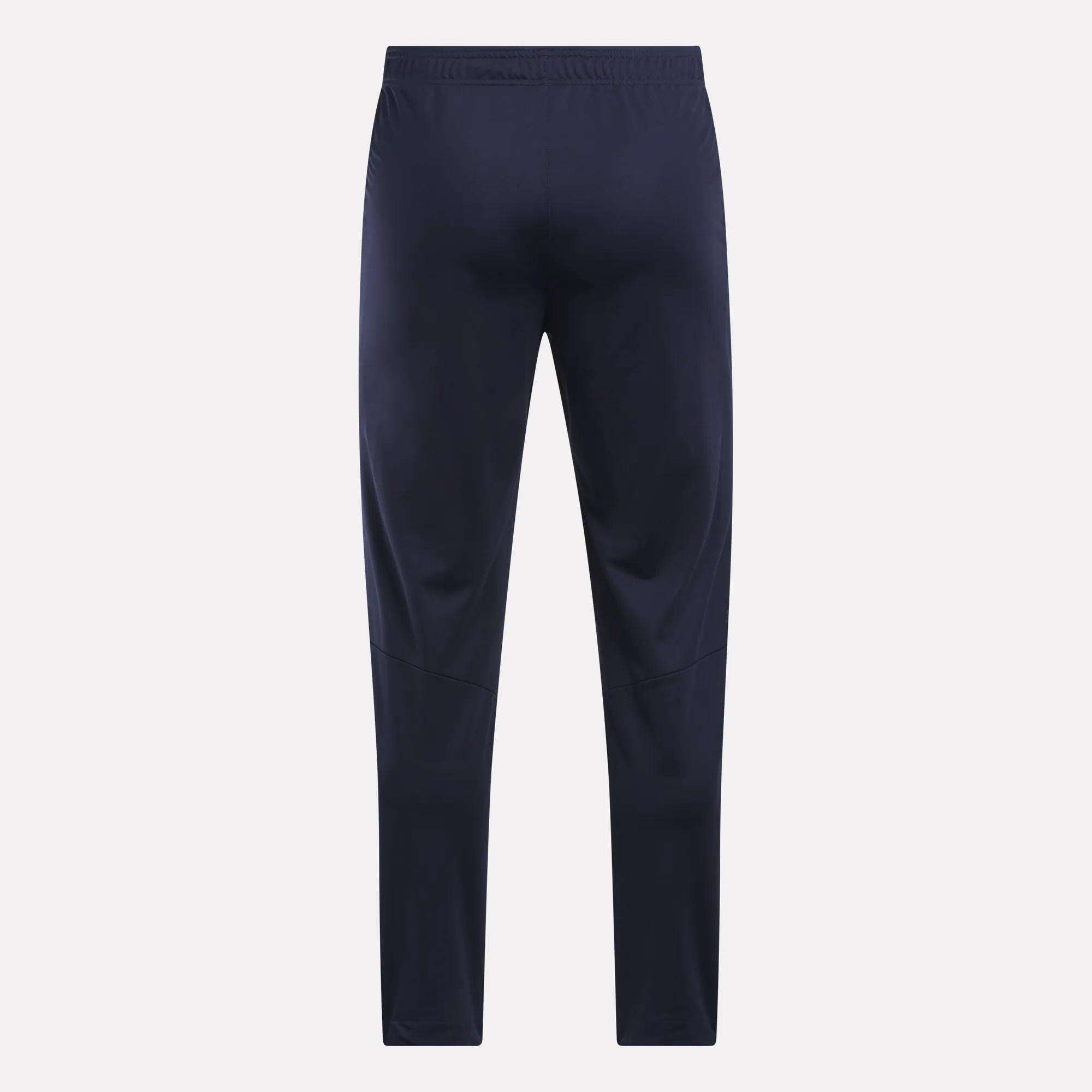 Men's Train Knit Pants by Reebok in navy blue, featuring an elastic waistband, displayed flat and facing forward against a plain light background.