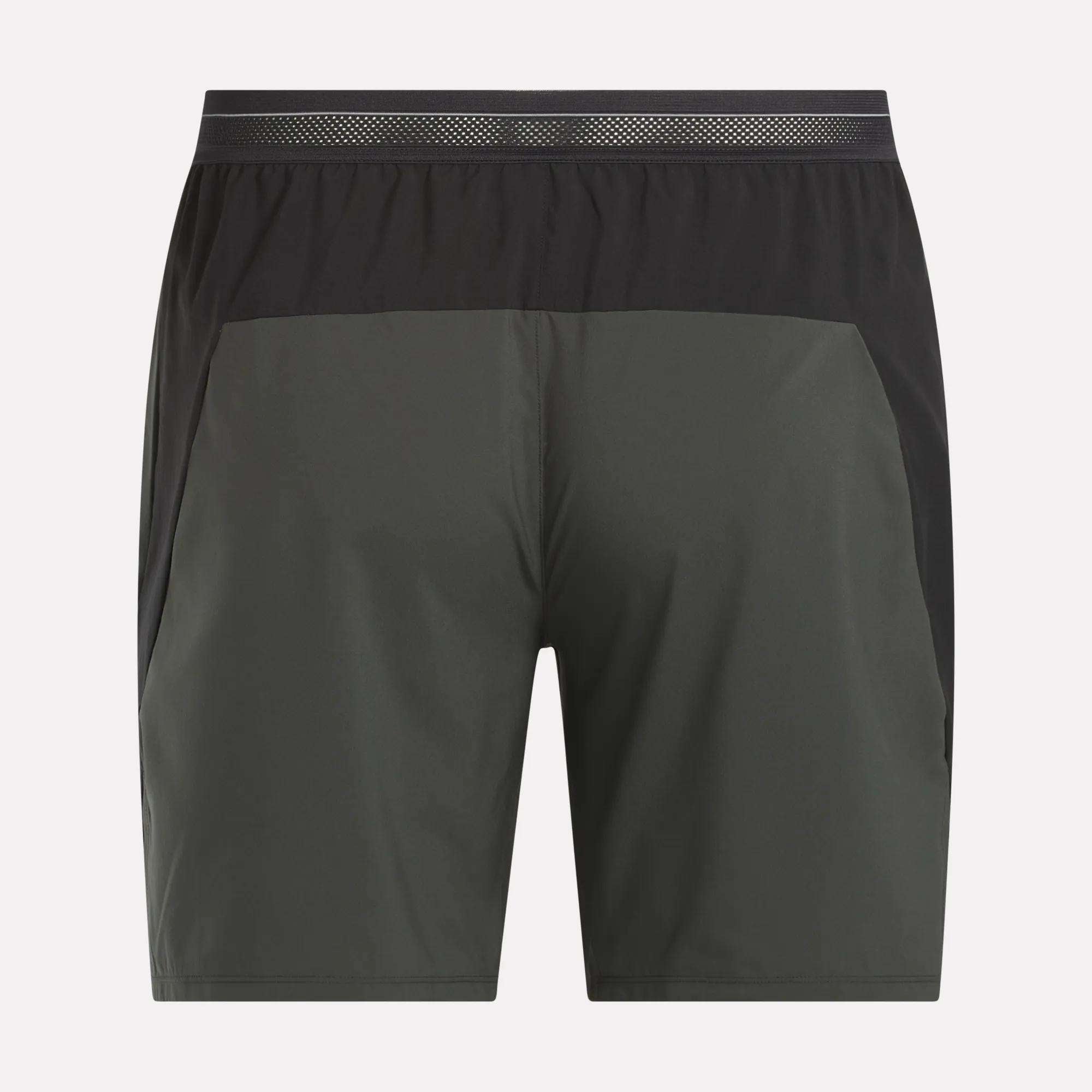 Reebok Men's Athlete Speed Shorts in dark gray with black elastic waistband and sleek side panels, shown on a white background. These training shorts offer a modern look and feature RBK-DRY technology for comfort. No visible logos or patterns.