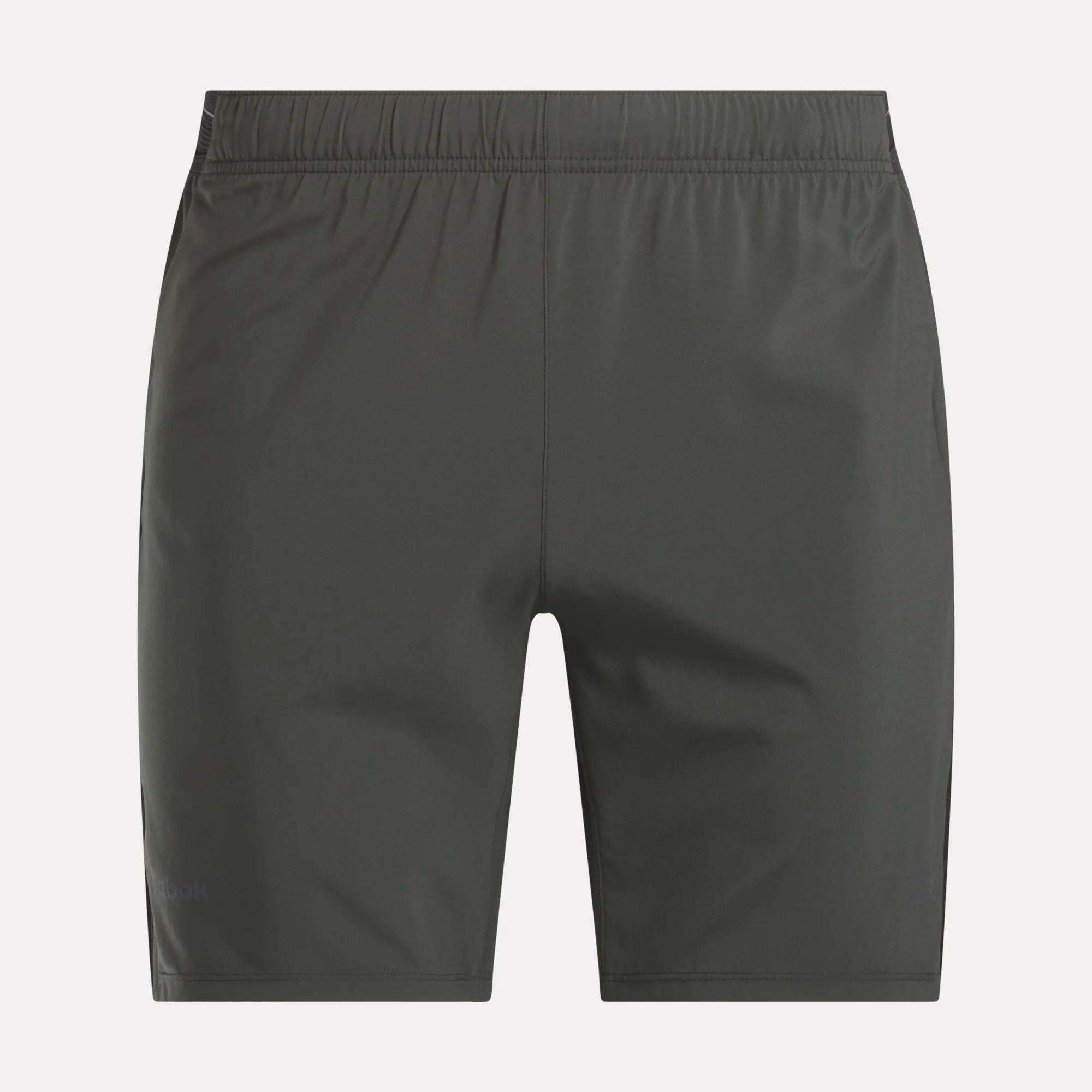 Men's Athlete Speed Shorts by Reebok in dark gray, featuring an elastic waistband and RBK-DRY fabric, shown flat from the back on a light background.