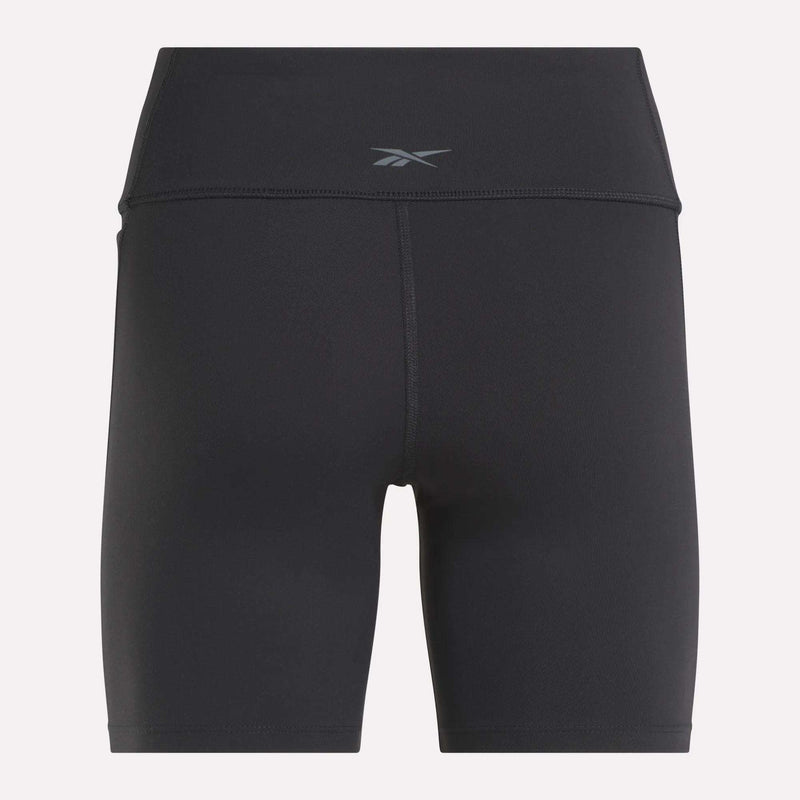 Back view of Reebok Women's Lux High-Rise Bike Shorts in black with a small waistband logo. Crafted from stretchy RBK-DRY fabric and designed with flatlock stitching for comfort and performance.