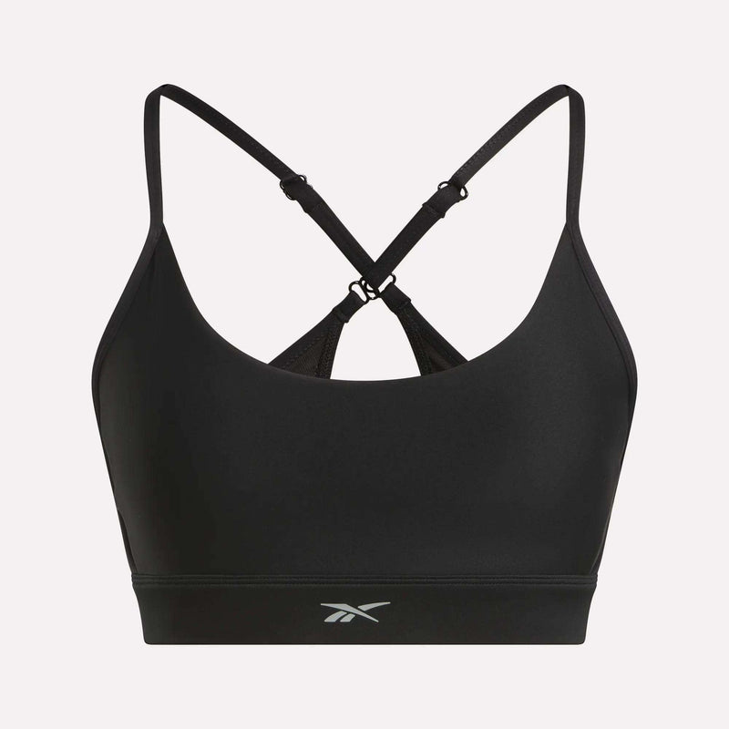 The Reebok Women's Lux Strappy Sports Bra features thin, adjustable crisscross straps, a small front logo, and delivers medium support with sweat-wicking comfort for your workouts.
