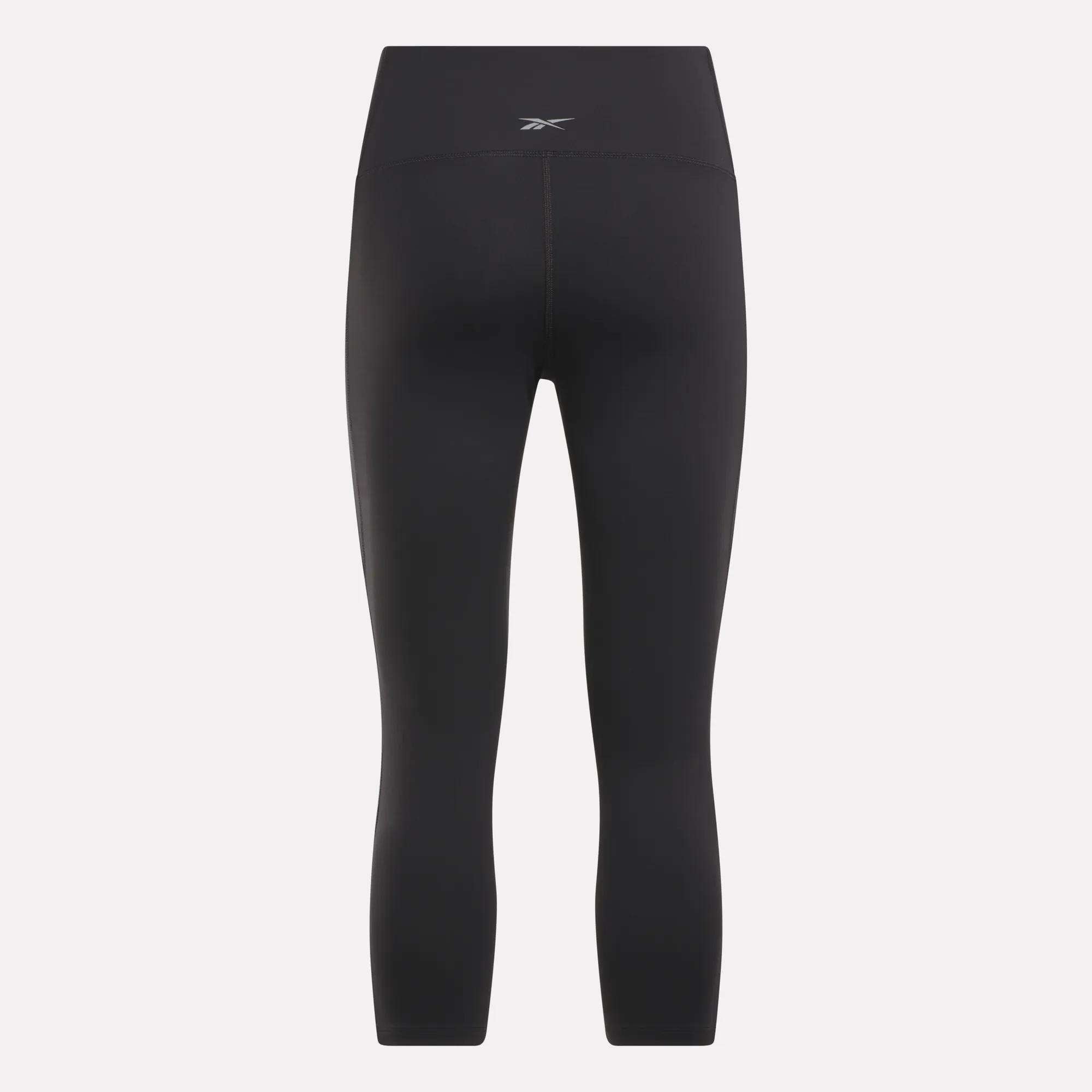 The Reebok Women's Lux 3/4 High-Rise Tights feature a high-rise waistband, a small logo at the center back, and a cropped ankle length—delivering style and comfort for your active lifestyle.