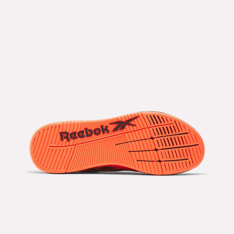 The image displays the bright orange sole of the Reebok Nano X5 Edge Training Shoes, featuring black Reebok branding and a traction pattern with horizontal and diagonal grooves. The background is solid white.