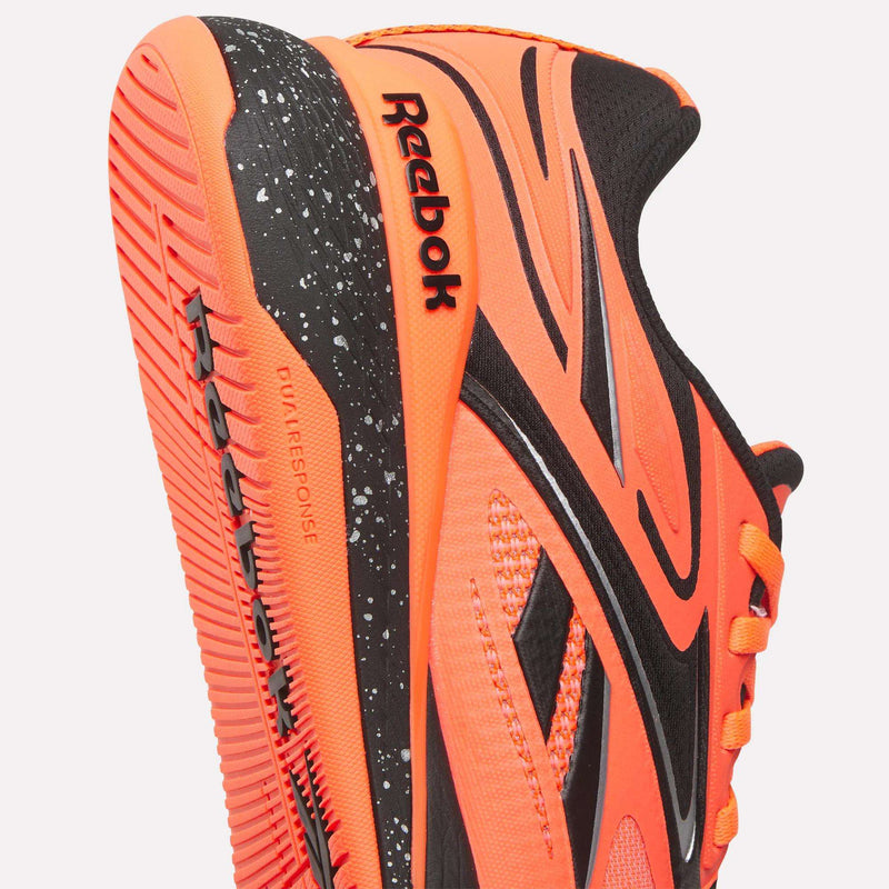 Close-up of Reebok Nano X5 Edge Training Shoes in orange and black, showcasing the performance sole with textured grip, Dual Response text, speckled midsole, and Reebok logos—durable and stylish for all training needs.