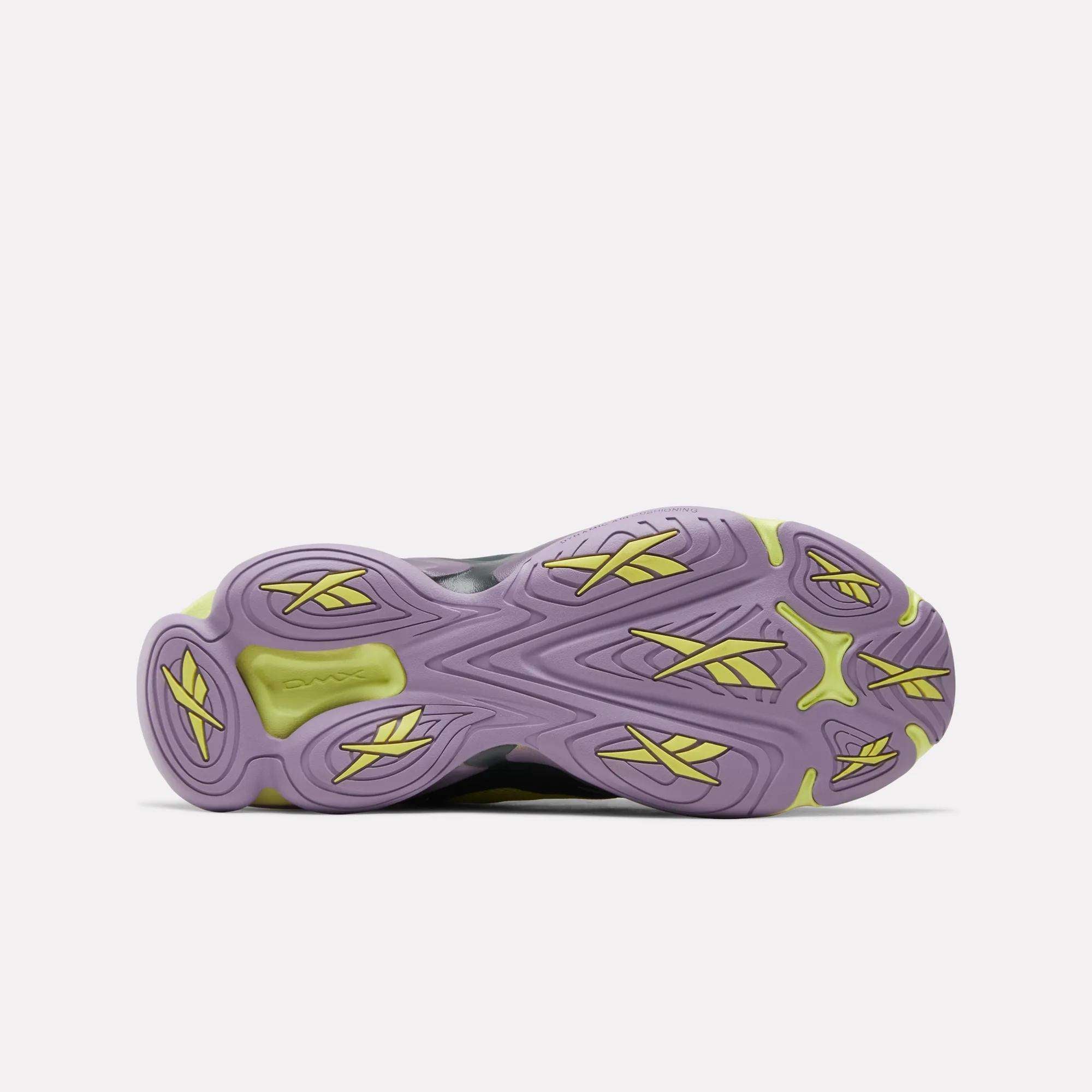 The image shows the sole of the Reebok DMX Series 3000 Shoes with a purple base, yellow accents, and wavy textured patterns, featuring "OZWEEGO" branding and hinting at DMX moving air technology for enhanced comfort.