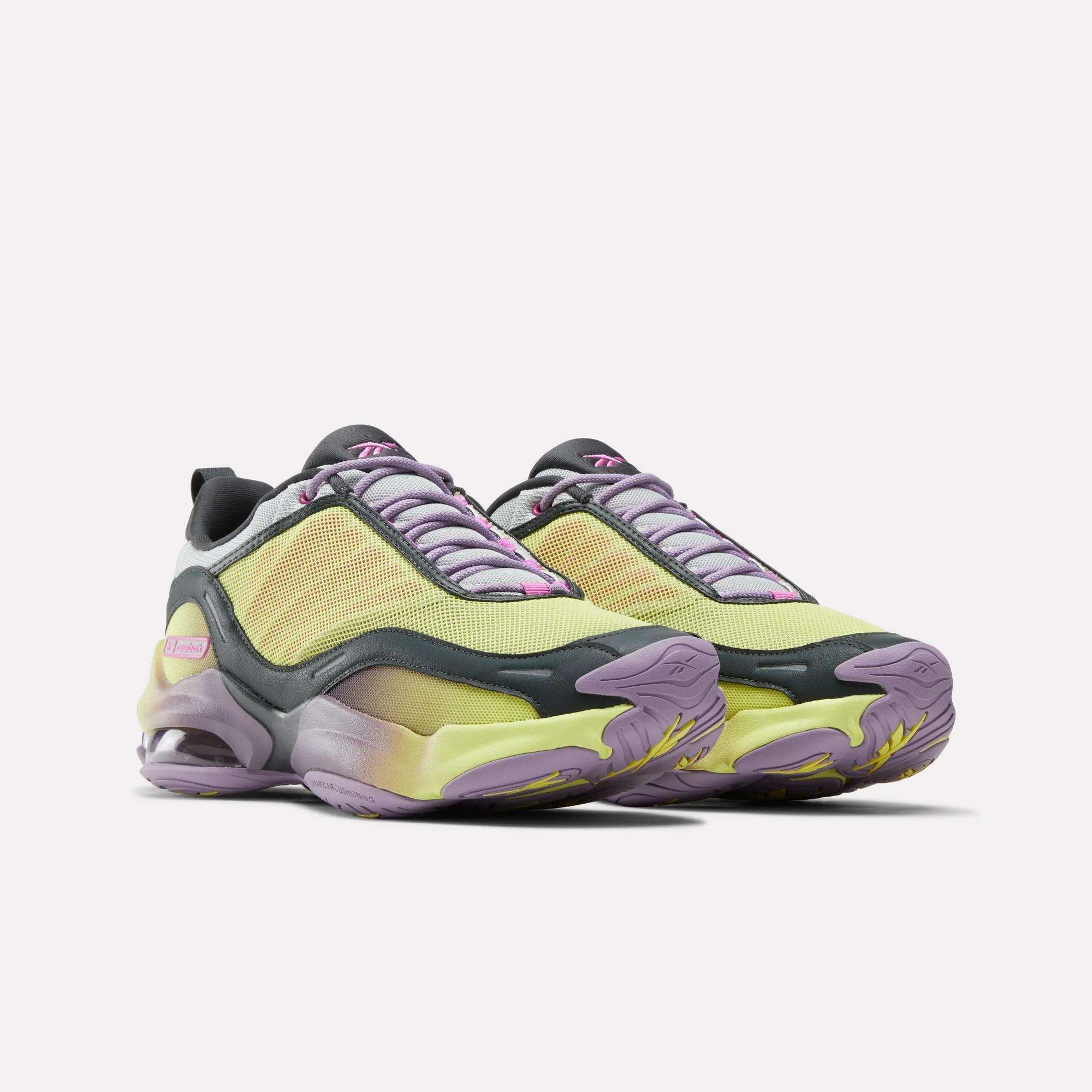 A pair of Reebok DMX Series 3000 Shoes with yellow mesh uppers, purple and gray accents, pink details, thick gradient soles featuring DMX moving air technology for comfort, and lavender laces shown on a white background.