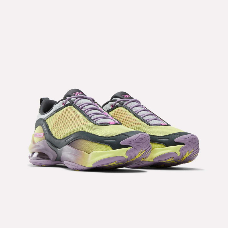 A pair of Reebok DMX Series 3000 Shoes with yellow mesh uppers, purple and gray accents, pink details, thick gradient soles featuring DMX moving air technology for comfort, and lavender laces shown on a white background.