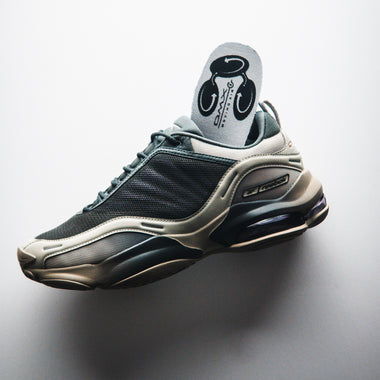 The Reebok DMX Series 3000 Shoes, shown in gray and beige with mesh and synthetic overlays, feature a chunky sole and visible DMX moving air cushioning for comfort. Displayed in a left side profile against a white background.