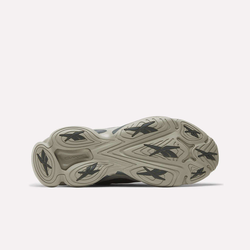 Bottom view of Reebok DMX Series 3000 Shoes with a light gray rubber outsole, multiple black Reebok logos, and a wavy tread pattern for traction and comfort, highlighting the brand’s innovative design.