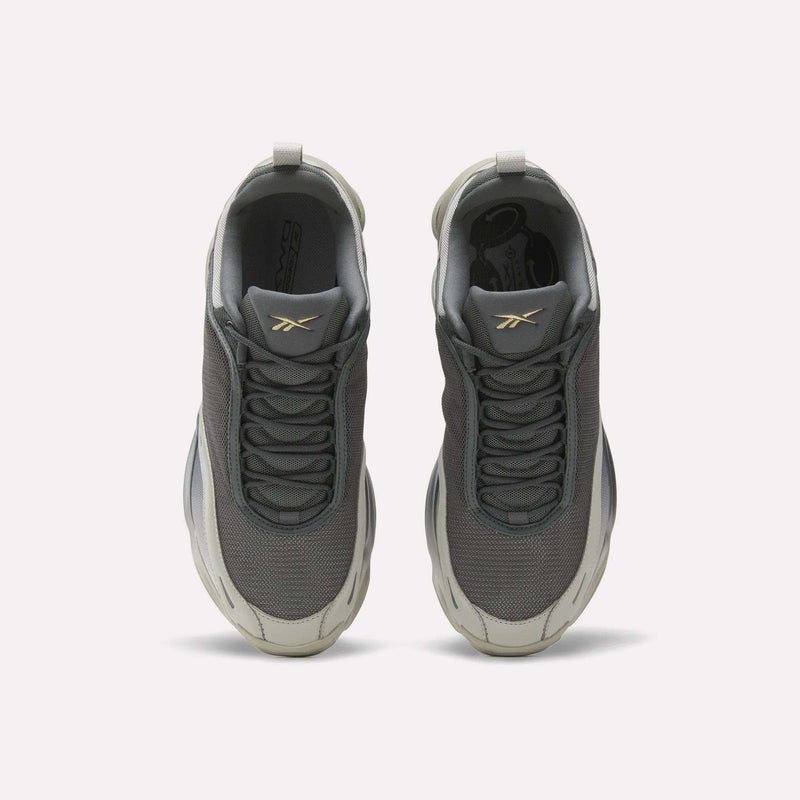 Top view of Reebok DMX Series 3000 Shoes in gray, with white soles, mesh uppers, and a gold logo on the tongues. Features DMX moving air technology for comfort. Displayed on a plain white background.