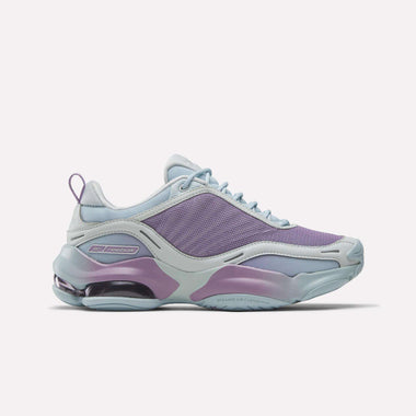 The Reebok Women's DMX Series 3000 Training Shoes feature a stylish light purple and blue mesh upper, smooth overlays, DMX 3 air-cushioned heel, and side Reebok logo for all-day comfort.