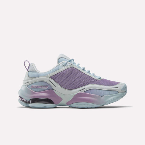 The Reebok Women's DMX Series 3000 Training Shoes feature a stylish light purple and blue mesh upper, smooth overlays, DMX 3 air-cushioned heel, and side Reebok logo for all-day comfort.