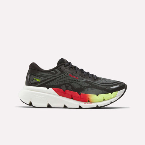The Men's FloatZig Double Running Shoes by Reebok feature a black and gray upper, thick white sole, and red to yellow gradient accents at the heel and midsole. Shown on a plain white background; ideal for max-cushioned miles.