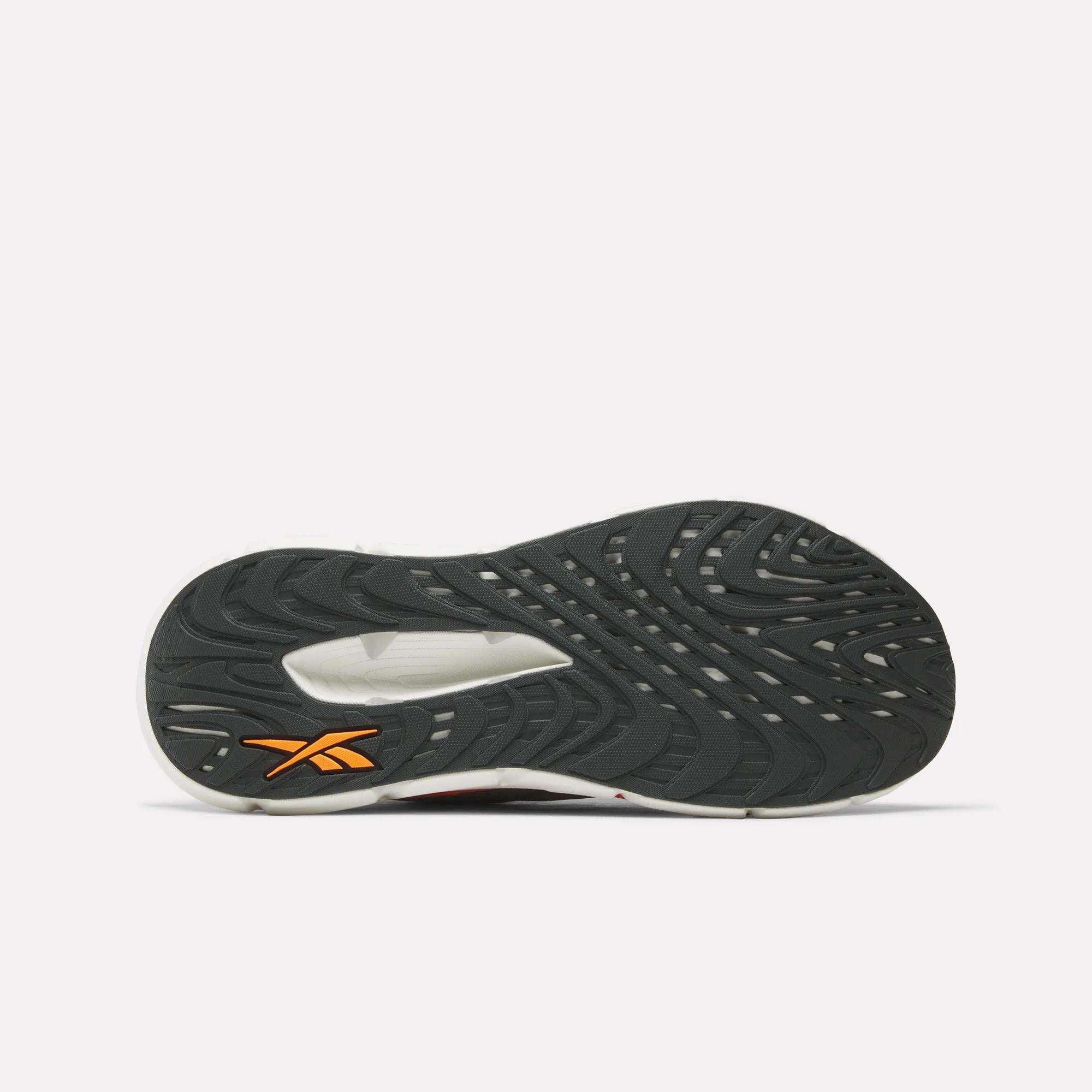 Bottom view of the Reebok Men's FloatZig Double Running Shoes features a textured black sole with a yellow Reebok logo at the heel and detailed tread patterns, designed for superior grip and cushioning on your run.