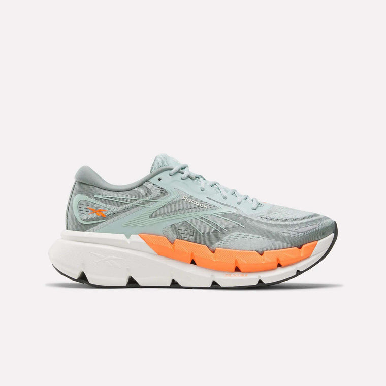 The Reebok Men's FloatZig Double Running Shoes are shown in profile, featuring light blue uppers with an orange accent above a thick white sole, designed for max-cushioned miles, against a plain white background.