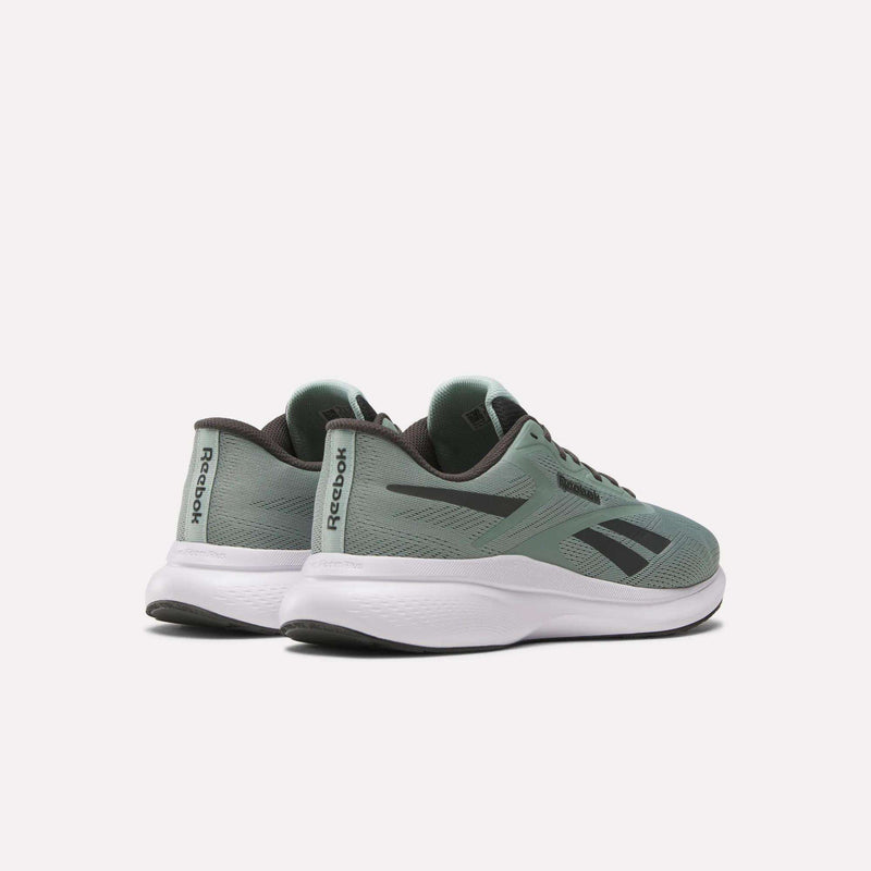 A pair of Men's Energen Run 4 Running Shoes by Reebok in green with black accents and white soles, featuring a lightweight design and breathable mesh upper, are shown on a light background at an angle to display side and back details.