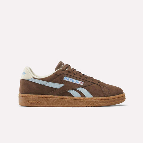 The Women's Club C Grounds UK Shoes by Reebok feature a brown retro design with light blue side stripes, cream heel tab, and a brown gum sole—ideal for anyone seeking stylish women's tennis shoes.
