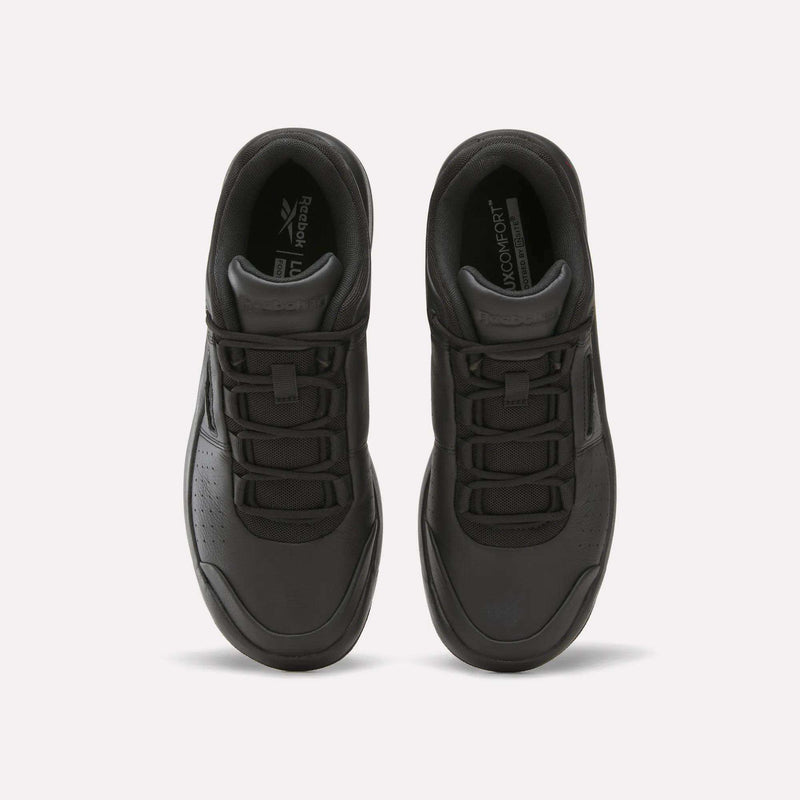 Top view of a pair of Reebok Dmx Comfort + Classic shoes in black, expertly crafted from premium leather with perforated toes, black laces, and signature branding on the tongue and insoles. Enhanced with DMX dynamic air cushioning for superior comfort, these walking shoes are displayed side by side on a plain white background.