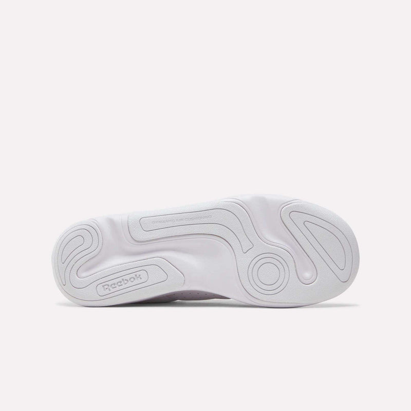 The white outsole of a DMX Comfort+ Classic shoe featuring a patterned tread, the Reebok brand name, and the embossed text DYNAMIC AIR CUSHIONING.