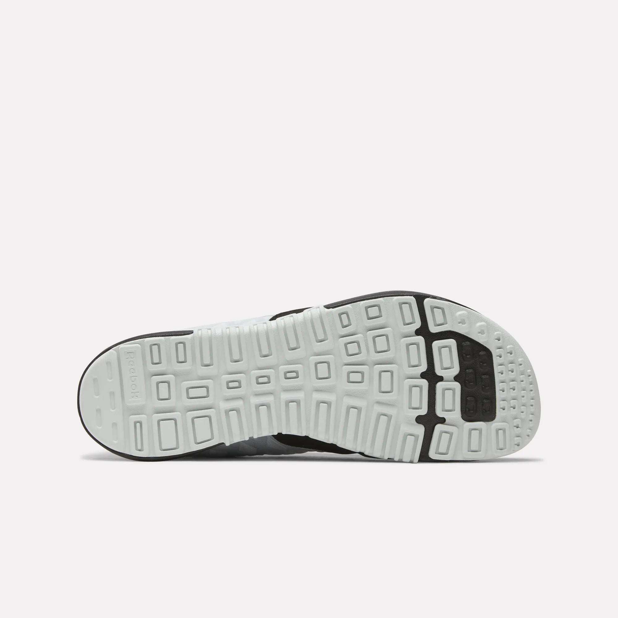 The image displays the sole of the Reebok Men's Nano 2.0 Training Shoes, featuring a geometric tread pattern with rectangular and square shapes in white and black rubber against a plain, light background.