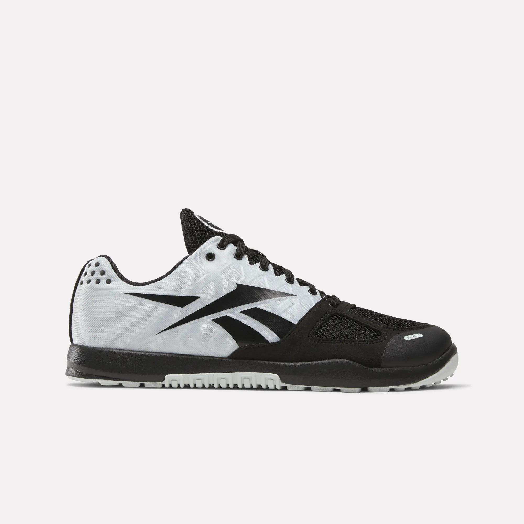 The Men's Nano 2.0 Training Shoes by Reebok feature a black toe, sole, and laces with a white side panel and bold black Reebok logo—ideal for functional fitness or classic training. Shown on a plain light gray background.