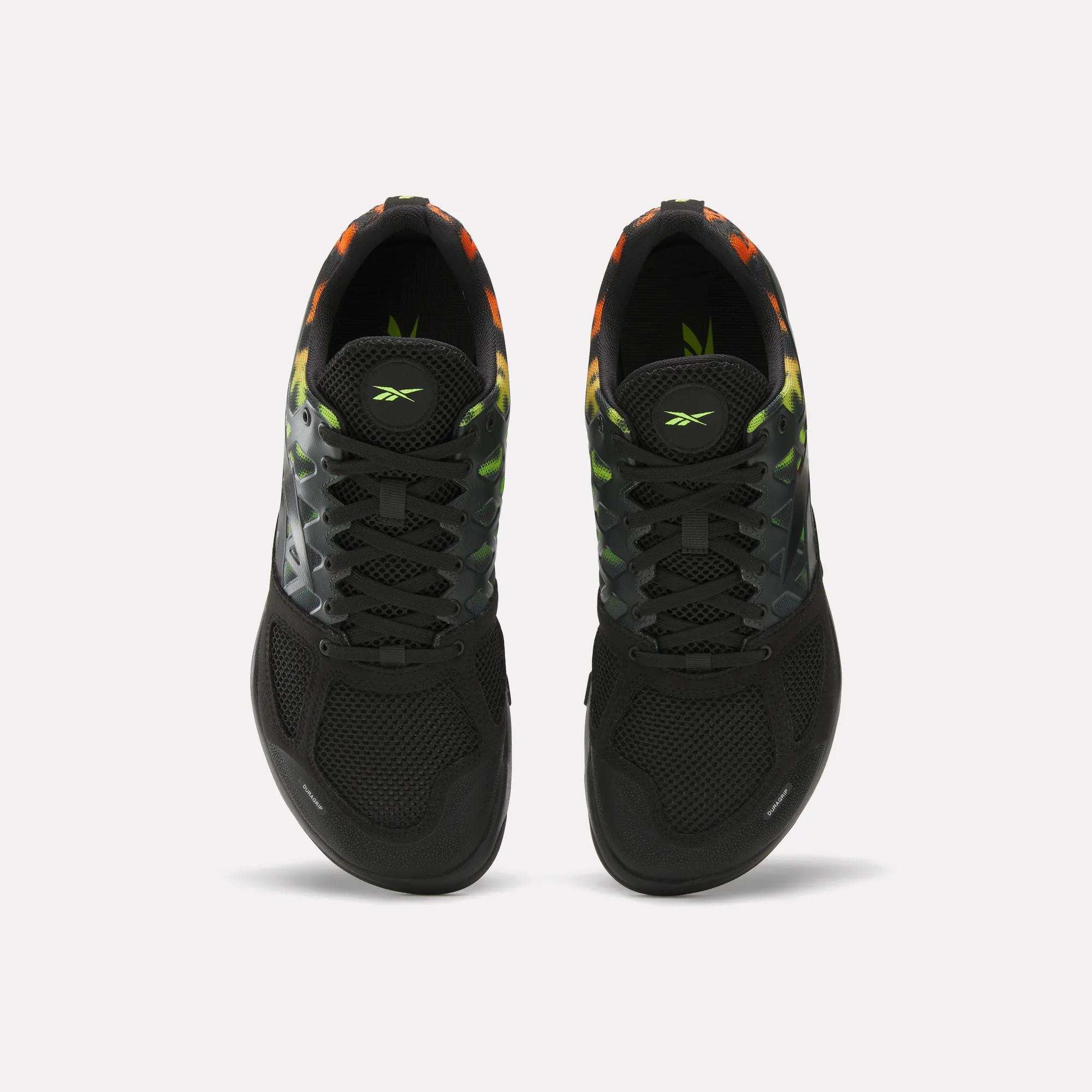 The Reebok Men's Nano 2.0 Training Shoes feature a black upper with mesh toe, gradient green and orange accents on the sides and collar, plus black laces—ideal for functional fitness and training sessions.