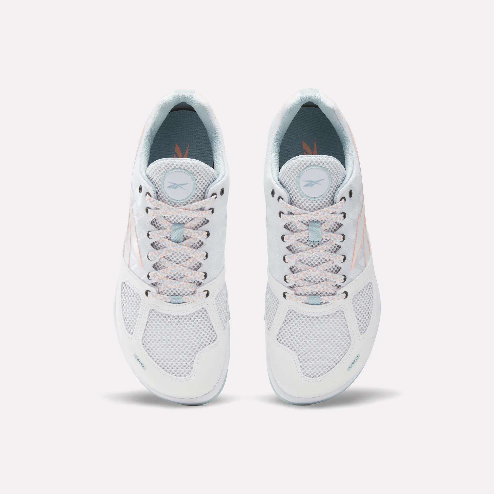 A top view of Reebok Men's Nano 2.0 Training Shoes in white with light blue accents, mesh panels, and pastel-patterned laces—ideal for functional fitness. The Reebok logo appears on each tongue.