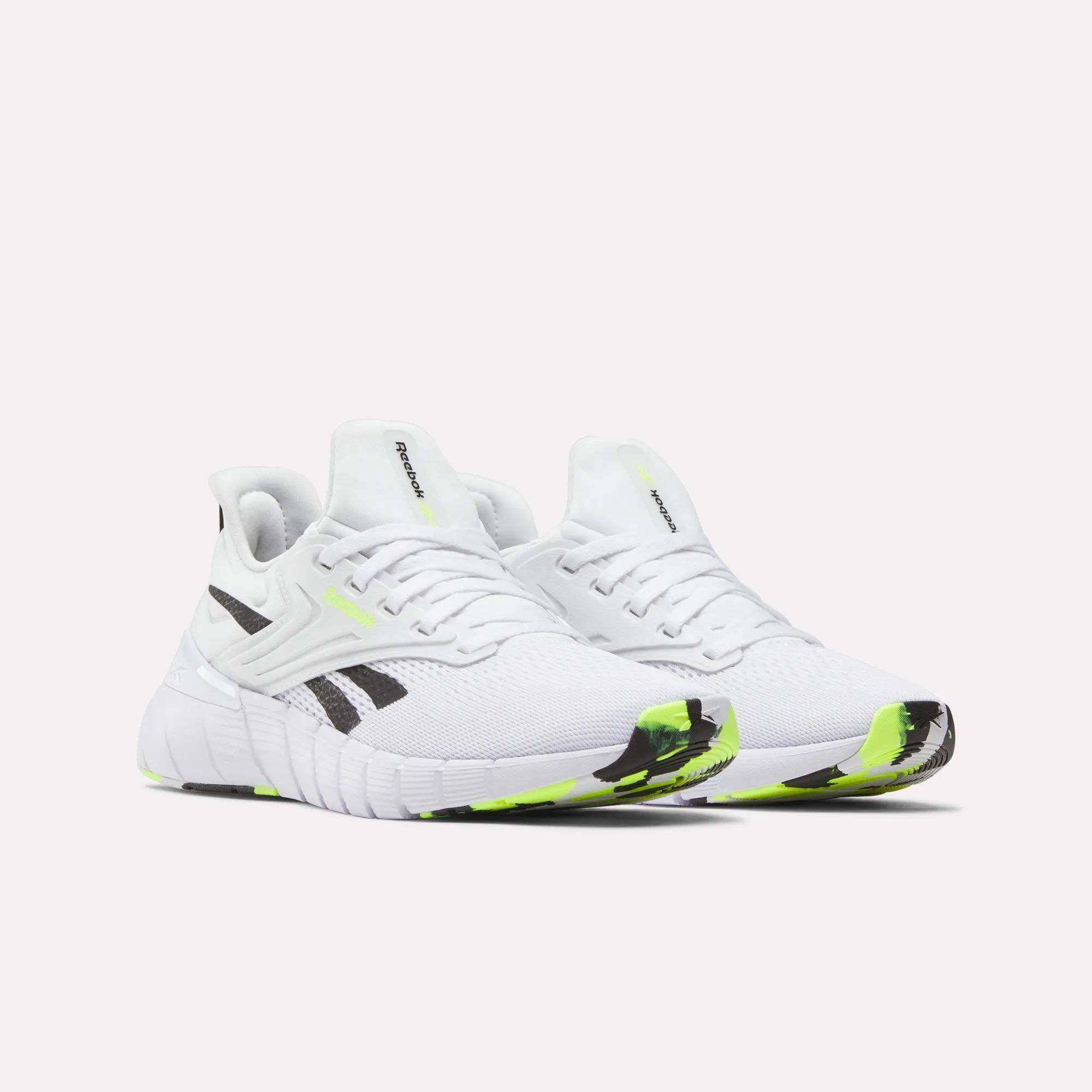 A pair of Reebok Women's Nano Gym Training Shoes with mesh uppers, chunky soles, and neon yellow accents designed for cross-training and weight training are displayed side by side on a plain white background.
