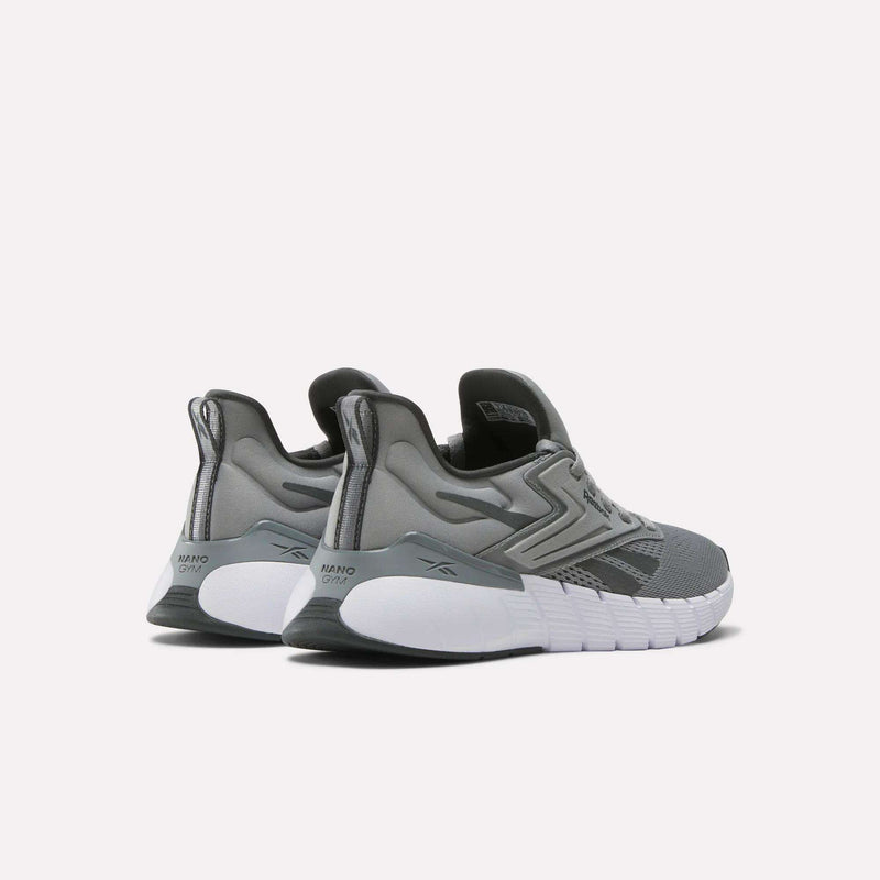 A pair of Reebok Women's Nano Gym Training Shoes in gray with white soles, viewed from the back and side, featuring Reebok branding and a textured heel for support—perfect for cross-training workouts.