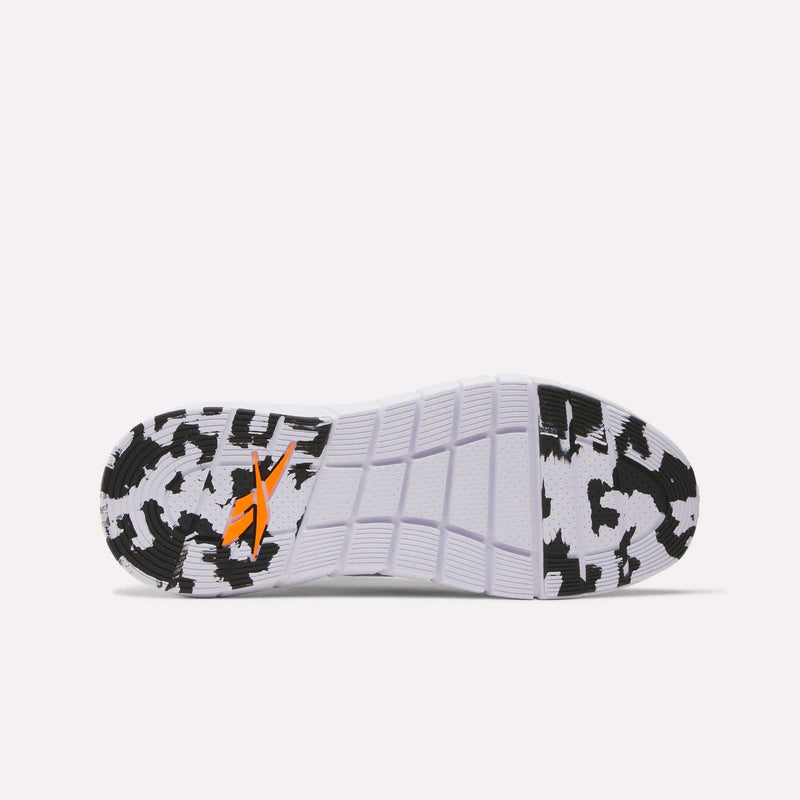 The image shows the sole of the Reebok Men's Nano Gym Training Shoes with a black and white cow print pattern. Rectangular grooves provide traction and grip, making them ideal for workouts.
