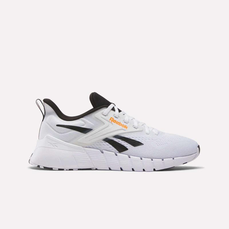 Men's Nano Gym Training Shoes by Reebok in white with black and gray accents, black Reebok logo, orange text, black tongue, performance foam collar, and white sole shown from the side on a plain background.