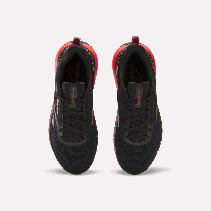 Top view of Reebok Men's Nano Gym Training Shoes in black with red accents and white midsoles, placed side by side on a white background.