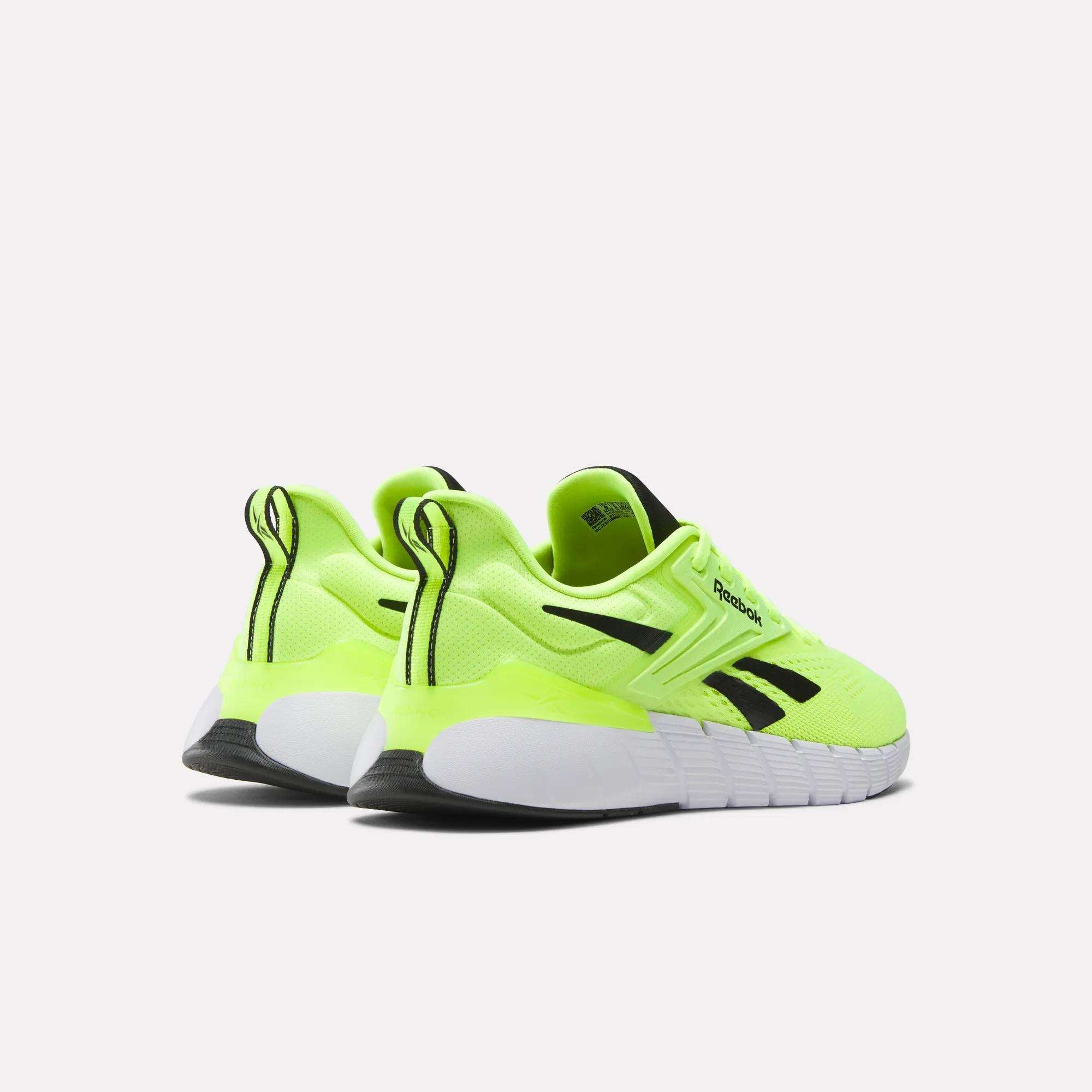 A pair of Reebok Men's Nano Gym Training Shoes in neon yellow with black and white accents shown from the back and side on a plain white background.