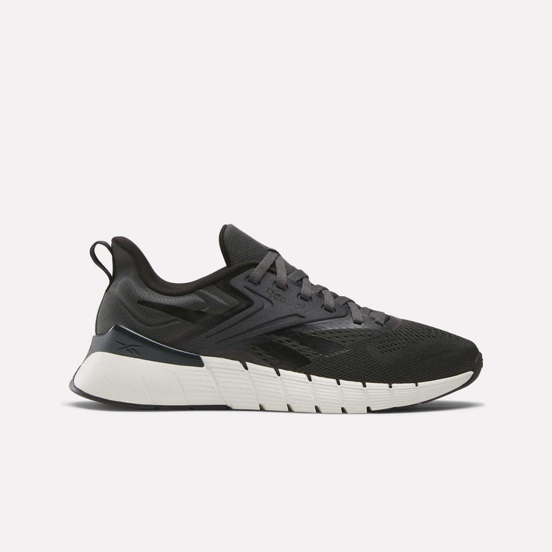 The Reebok Men's Nano Gym Training Shoe in black and gray features a thick, textured white and black sole, shown side-on against a plain light background.
