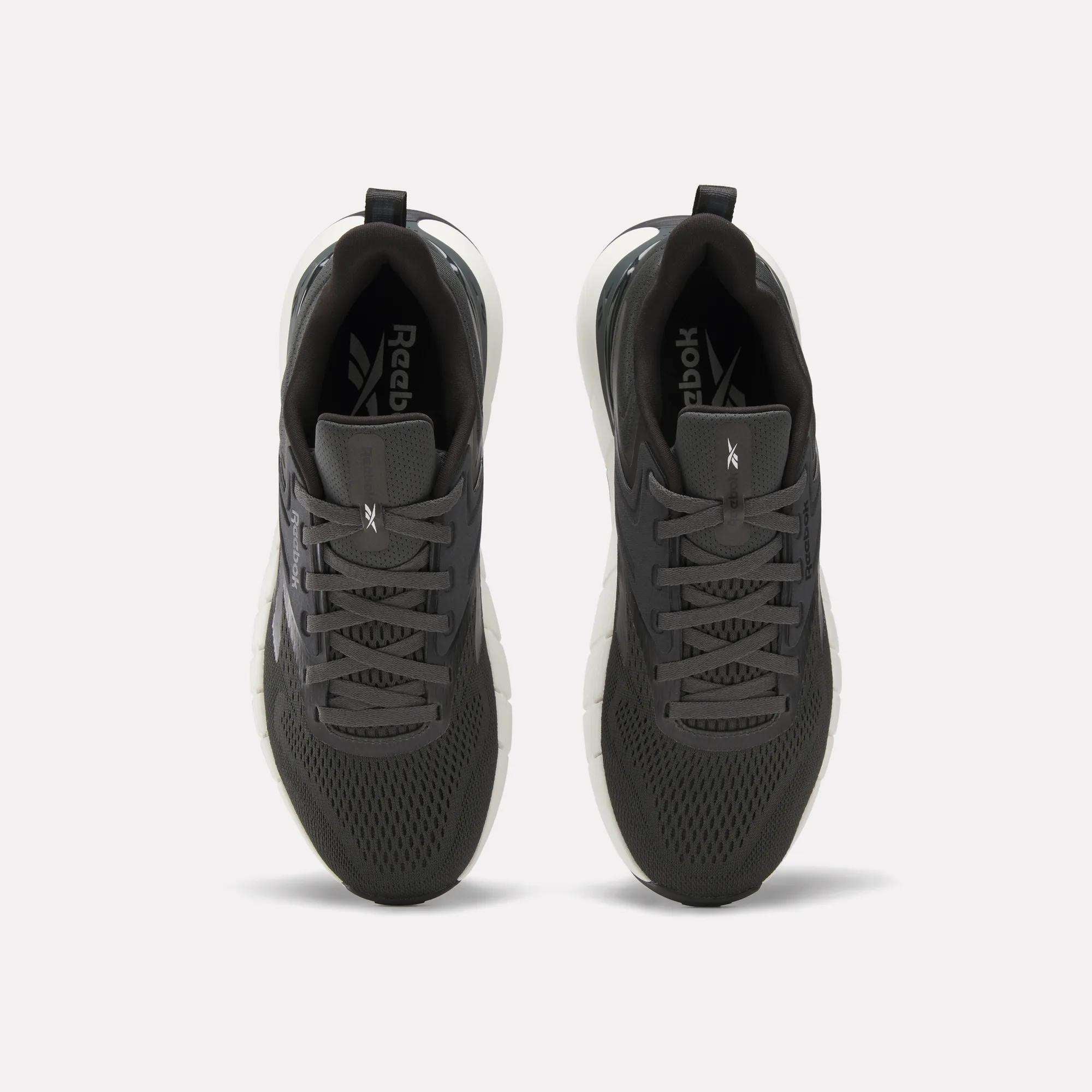 A pair of Reebok Men's Nano Gym Training Shoes in dark gray, shown from above with mesh uppers, black laces, and white soles—perfect for training, displayed on a plain white background.