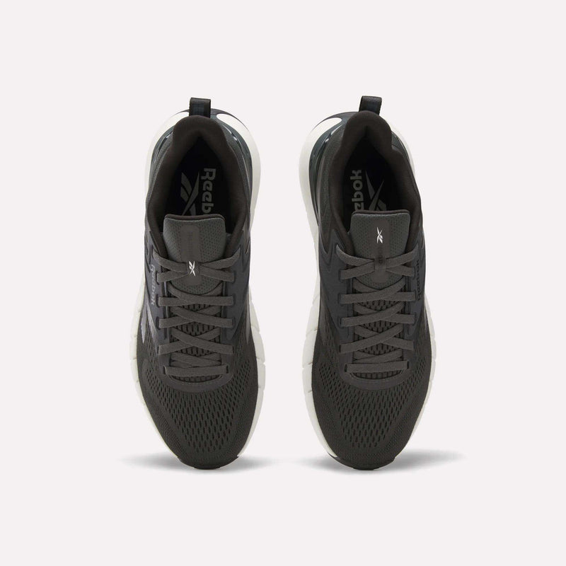 A pair of Reebok Men's Nano Gym Training Shoes in dark gray, shown from above with mesh uppers, black laces, and white soles—perfect for training, displayed on a plain white background.